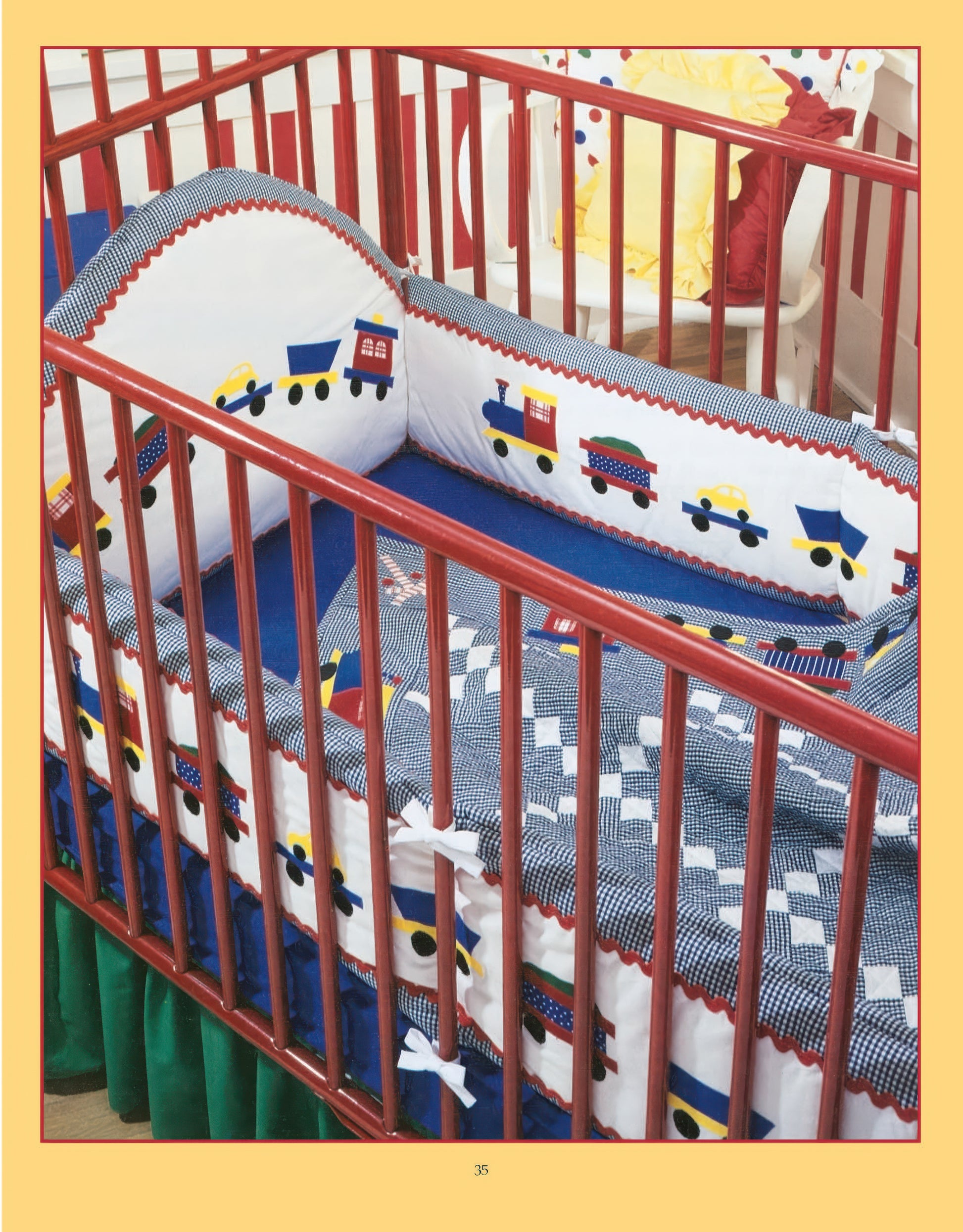 The Rock-a-Bye Quilts Digital Download by Leisure Arts features a wooden baby crib with blue and white bedding, colorful train and car appliqués, soft bumper pads, a green skirt underneath, and a yellow pillow on a chair in the background.