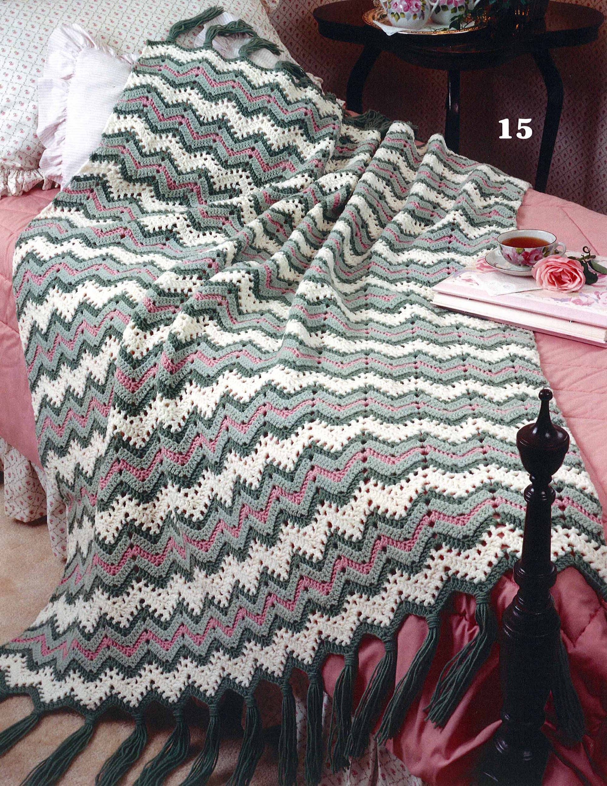 The Rippling Effects digital download by Leisure Arts features 16 afghan designs, perfect for home decor, including chevron ripple patterns in vibrant colors, ideal to drape over your bed for a cozy touch.