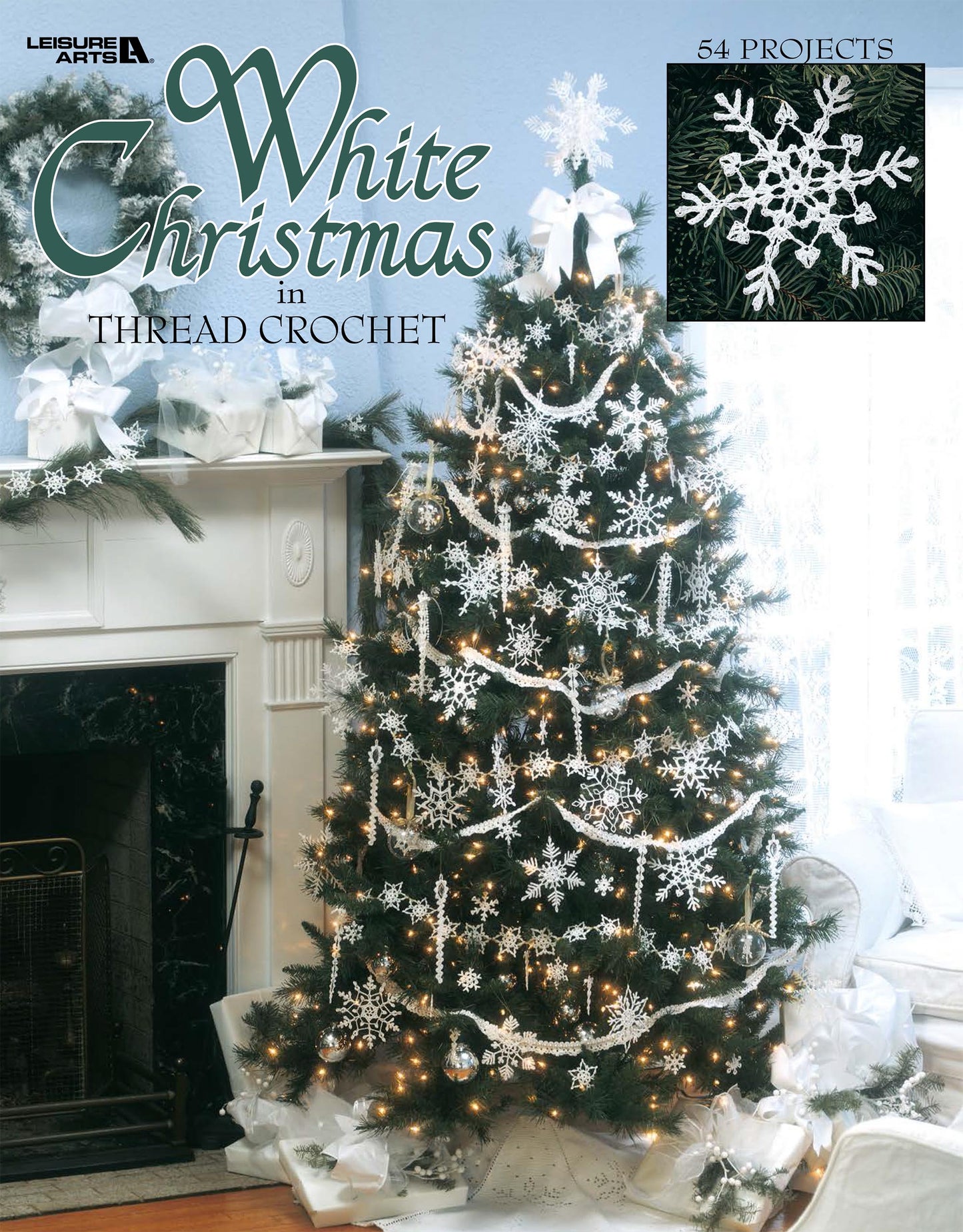 A Christmas tree adorned with white crochet ornaments stands by a fireplace. The cover reads "White Christmas in Thread Crochet Digital Download" by Leisure Arts, noting 54 holiday decor projects in the top right corner.