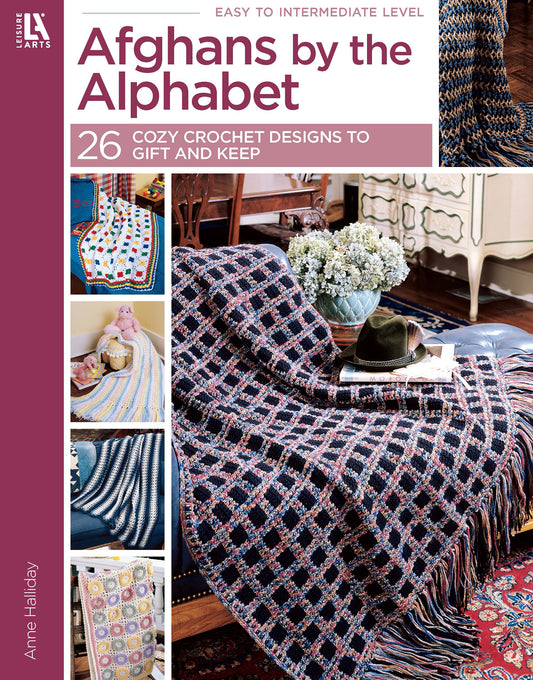 Cover of Afghans by the Alphabet Digital Download from Leisure Arts features cozy crochet designs over a chair and sofa, with 26 patterns—including baby blankets—to gift or keep, plus a table with books, flowers, and glasses.