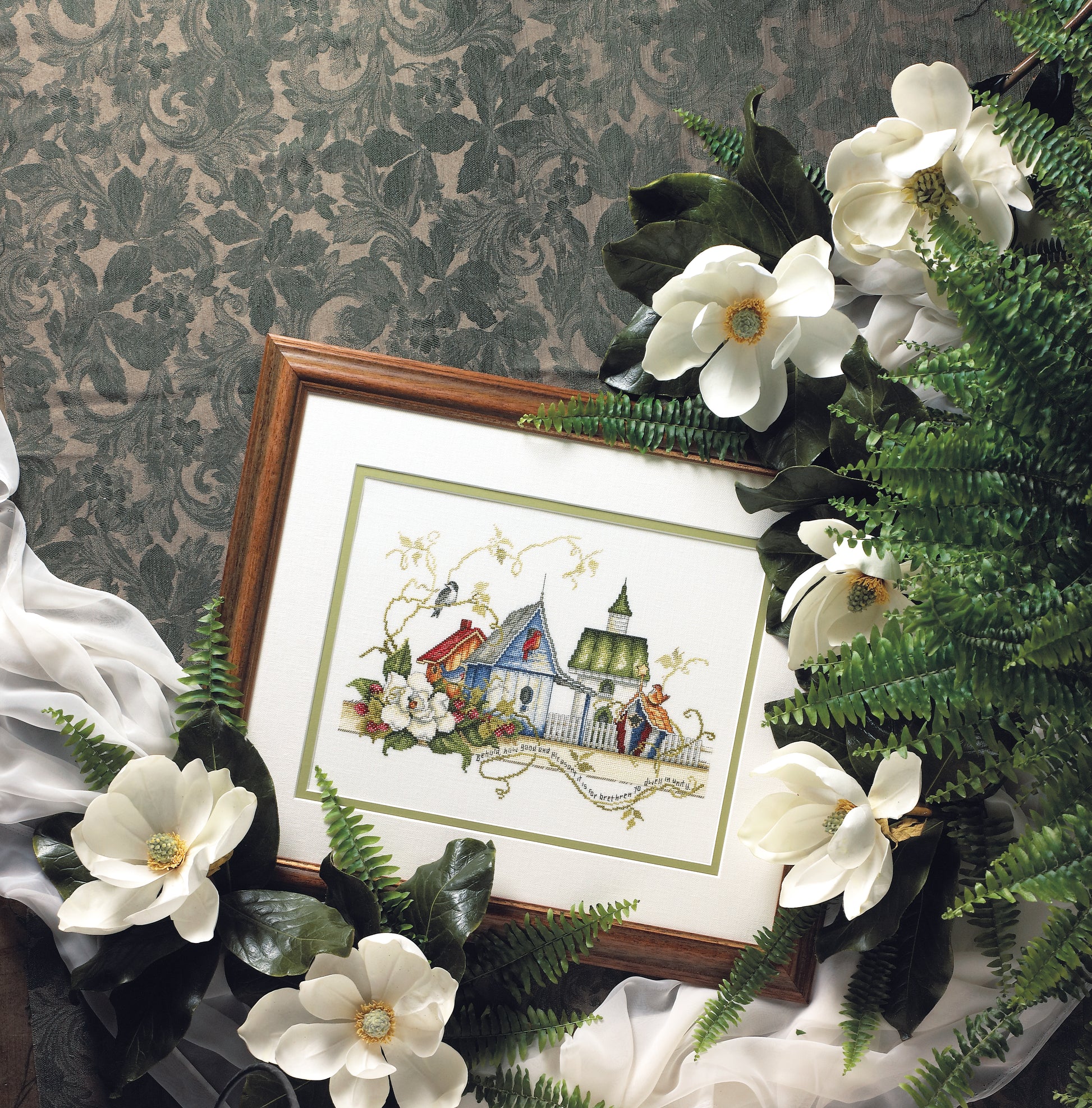 The Unity Birdhouses Cross Stitch Digital Download by Leisure Arts features charming birdhouses and floral motifs, beautifully arranged with greenery on a patterned backdrop for a delightful, craft-ready design.