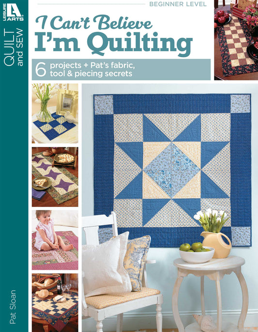 The cover of Leisure Arts' "I Can't Believe I'm Quilting Digital Download" features a blue and beige star-pattern quilt, fabric crafts, and a smiling woman quilting, highlighting beginner-friendly step-by-step instructions.