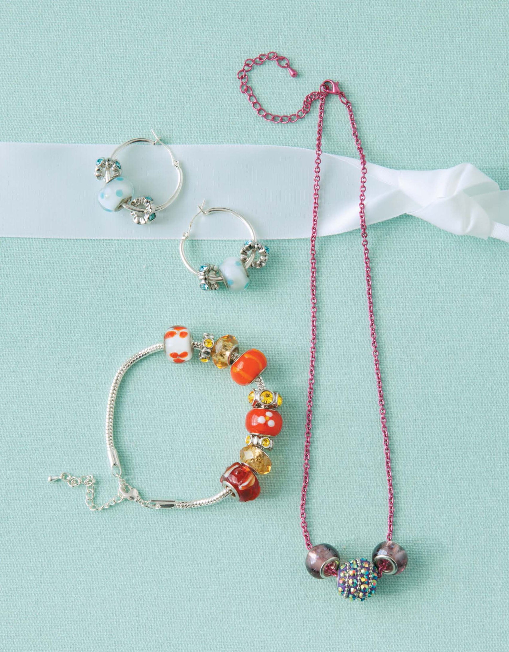 Get inspired for beginner jewelry projects with the Oh-So-Easy Jewelry Digital Download by Leisure Arts—featuring designs like silver hoop earrings with blue and white beads, a colorful beaded bracelet, and a purple necklace.