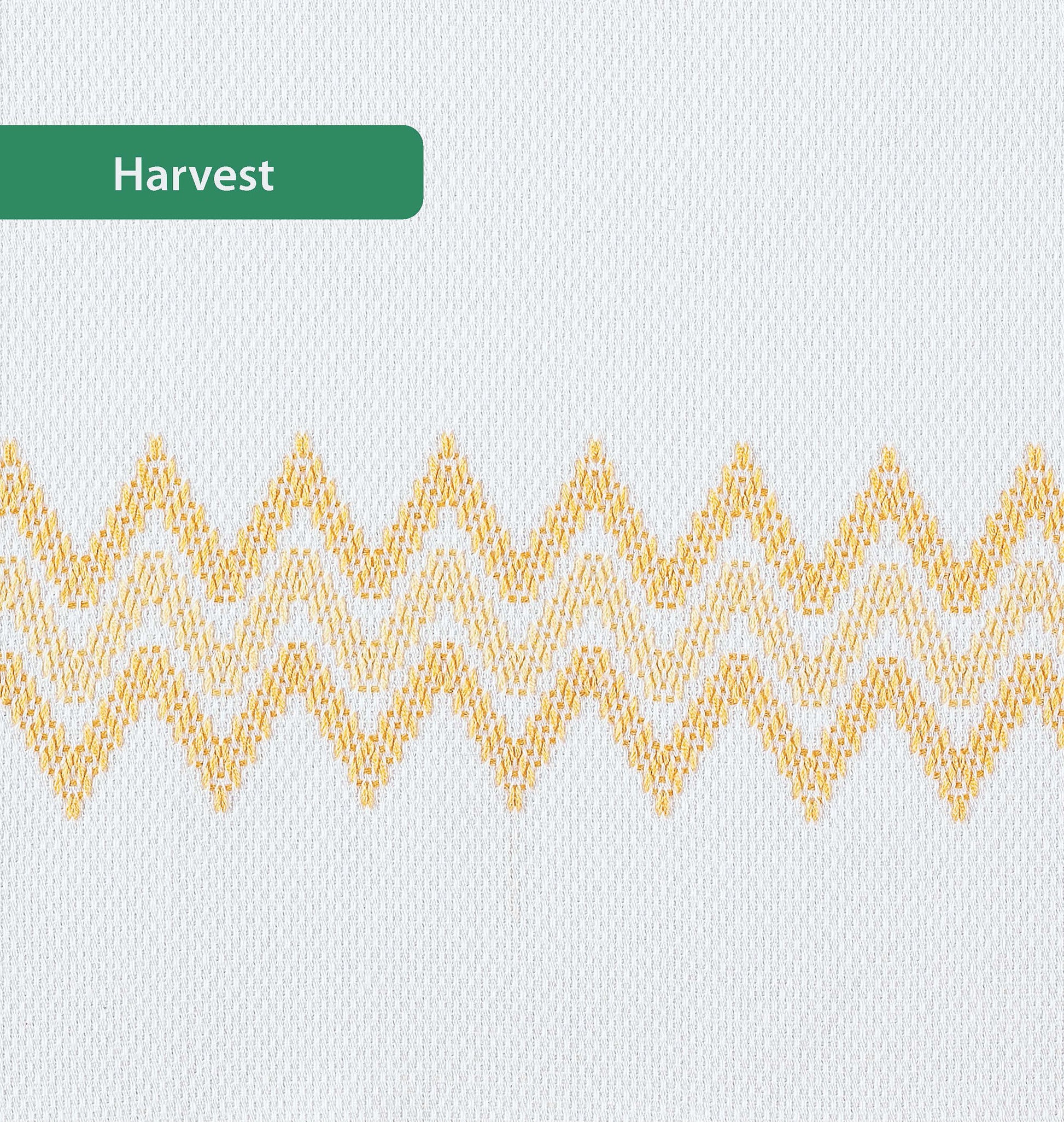 The Easy-Does-It Swedish Weave Towels by Leisure Arts feature white fabric with a yellow and orange horizontal zigzag pattern made using Swedish Weave. A green label in the top left corner reads "Harvest.