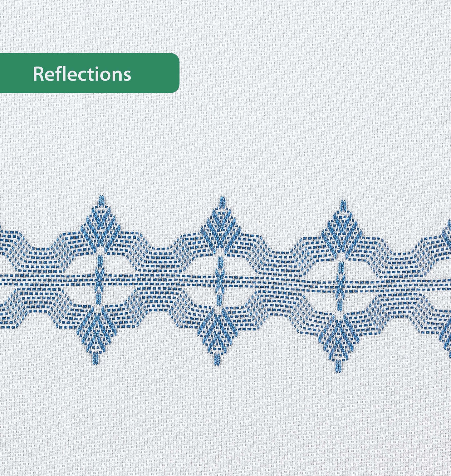 A white Easy-Does-It Swedish Weave Towel by Leisure Arts features a geometric blue embroidered band across the center. A green label in the upper left reads "Reflections.