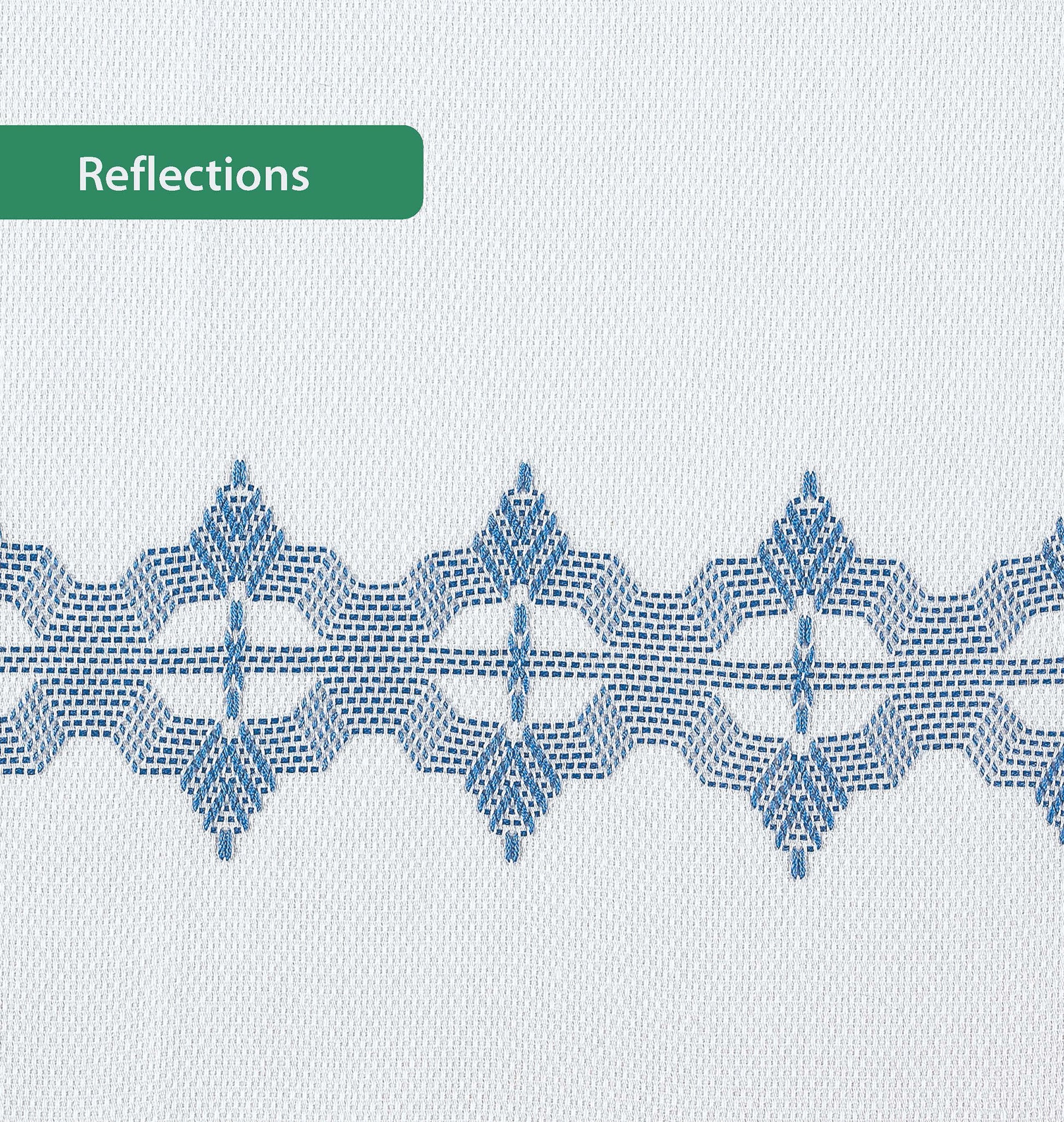 A white Easy-Does-It Swedish Weave Towel by Leisure Arts features a geometric blue embroidered band across the center. A green label in the upper left reads "Reflections.