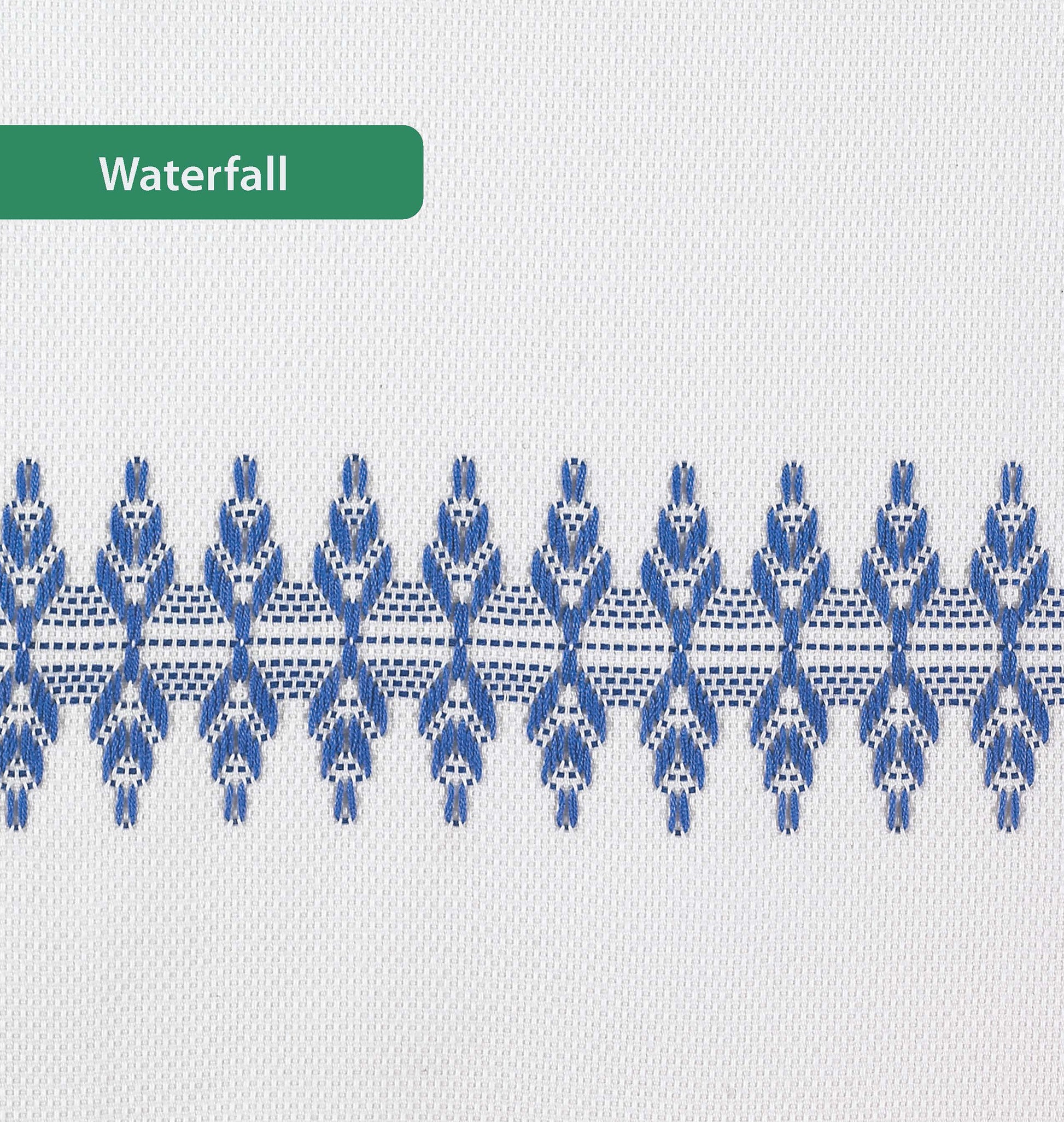 A white towel from Leisure Arts' Easy-Does-It Swedish Weave Towels features a horizontal row of blue embroidery and a green Waterfall label. Ideal for sparking inspiration for your next embroidery floss project.