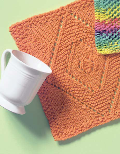 The Kitchen Bright Dishcloths by Leisure Arts—a white ceramic pitcher next to a textured orange knit and a multicolored swatch—make stylish home accents or practice pieces, all set on a pale green backdrop.