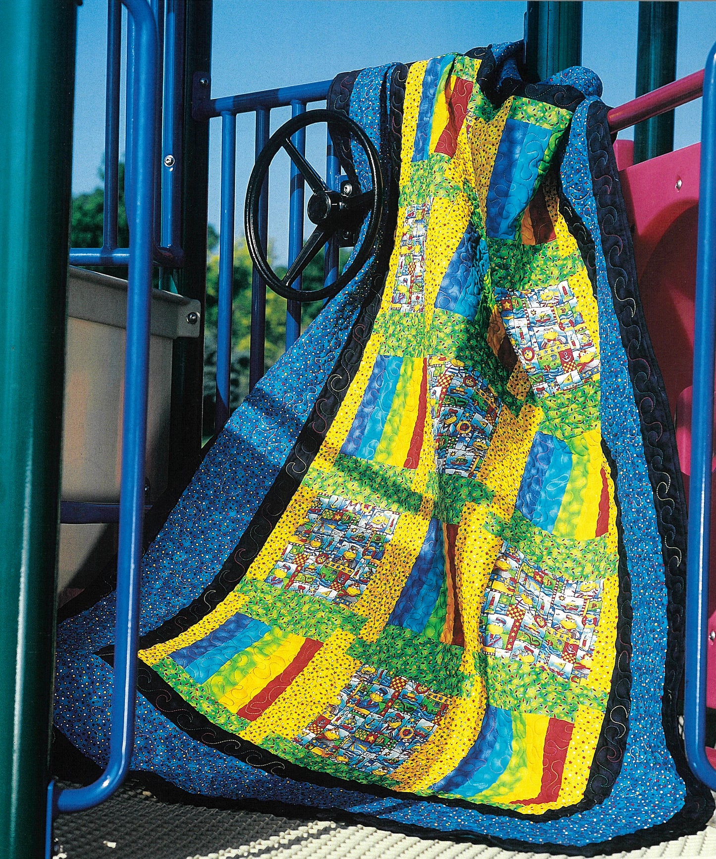 The Quick & Scrappy Quilts by Leisure Arts features colorful blue, yellow, green, and multicolored patchwork patterns draped over playground equipment with a steering wheel, pink and blue bars, and trees in the background.