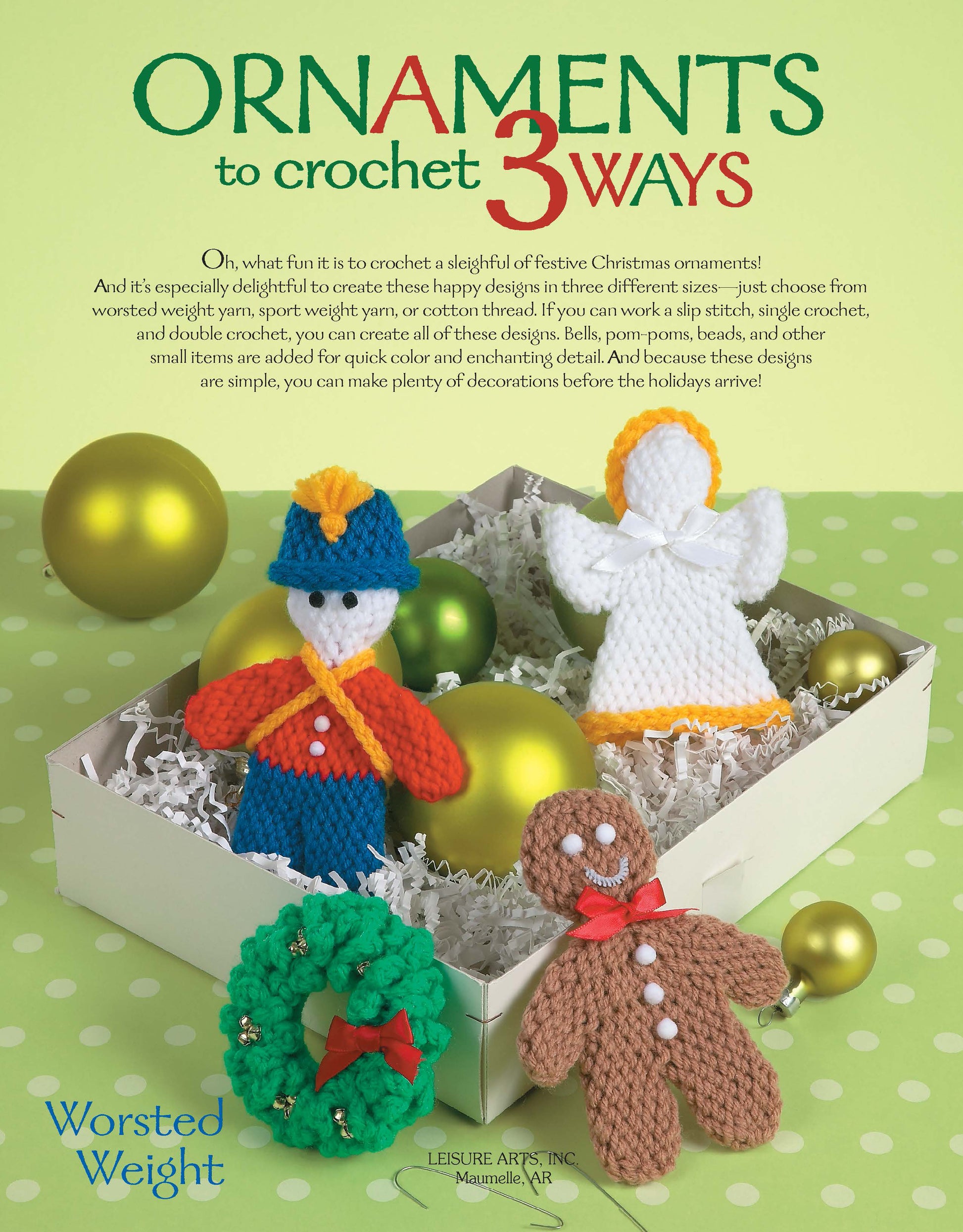A cheerful display showcases Leisure Arts’ Ornaments to Crochet 3 Ways Digital Download—featuring beginner holiday patterns for an angel, gingerbread person, snowman, and wreath—amid green and gold baubles.