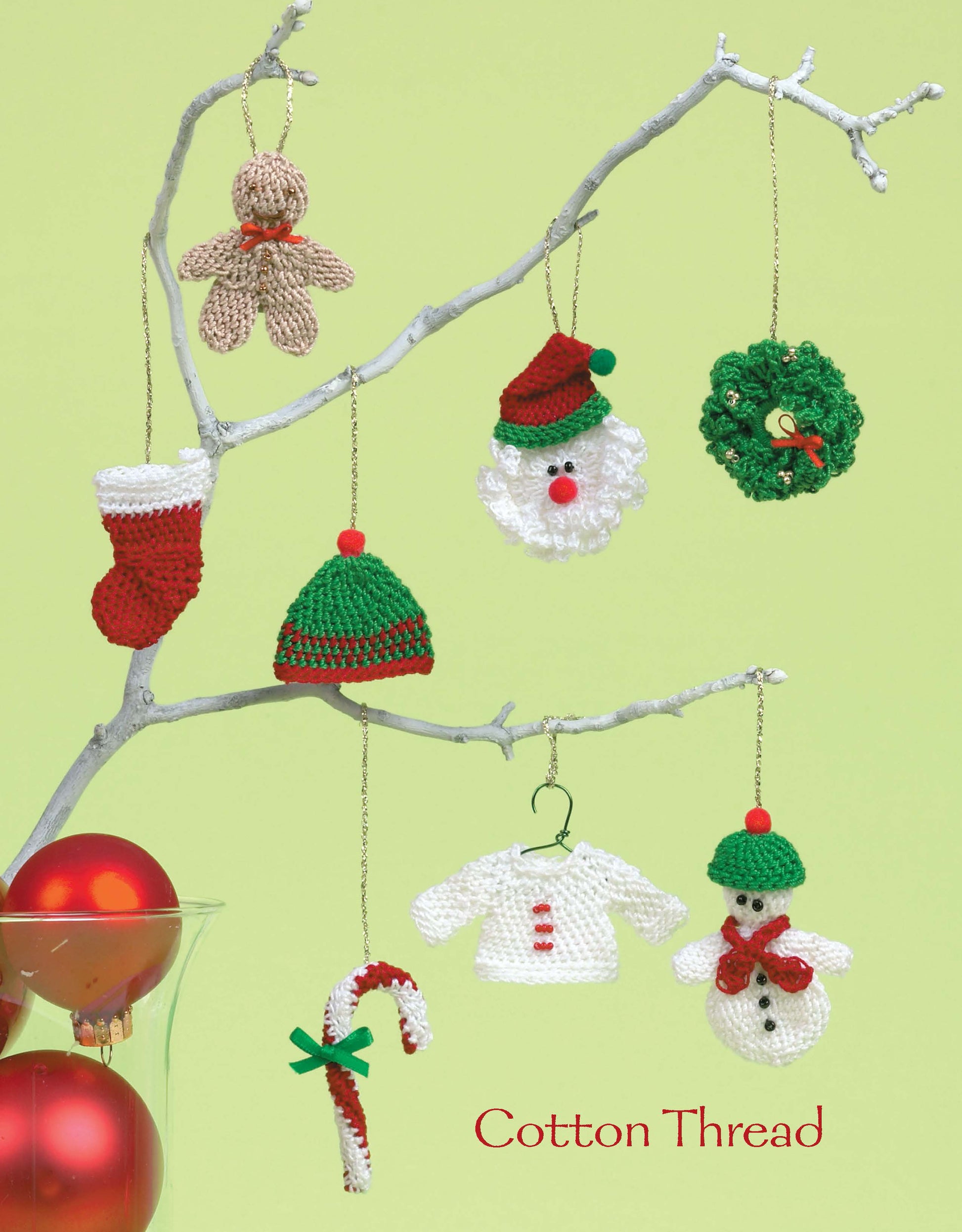A white branch displays ornaments made from the Leisure Arts Ornaments to Crochet 3 Ways Digital Download: gingerbread, stocking, Santa head, wreath, hat, sweater, candy cane & snowman. Red ornaments fill a glass below. Text reads Cotton Thread.