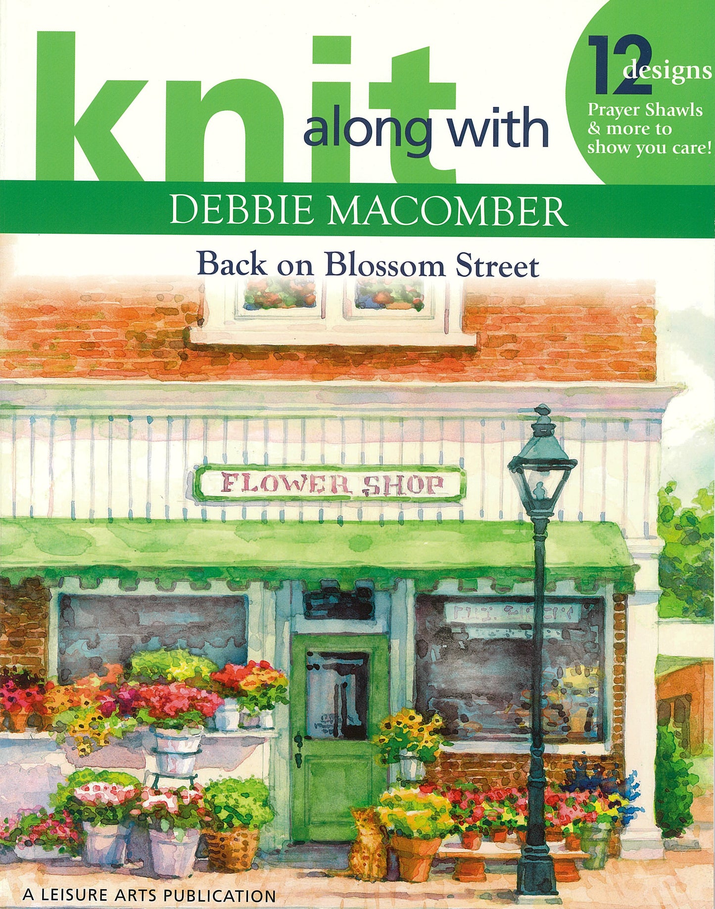 The cover of Knit Along with Debbie Macomber—Back on Blossom Street by Leisure Arts features a watercolor flower shop and promotes 12 knit designs, including cozy prayer shawls.