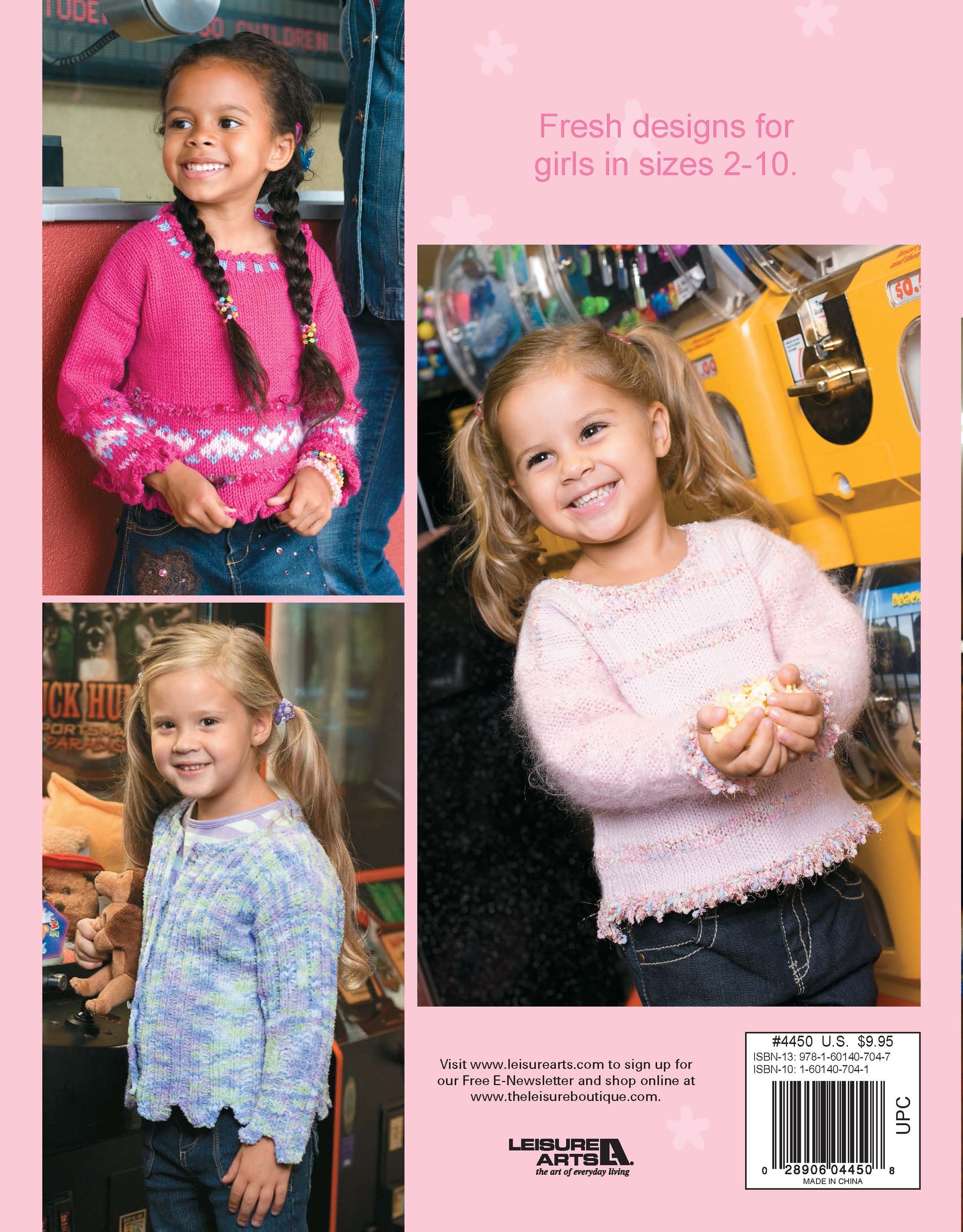 Three young girls pose in Leisure Arts Fun Time Sweaters—hand-knit pullovers in pink, purple, and white—by arcade claw machines. A pink background highlights girls’ sweater designs and knitting patterns.