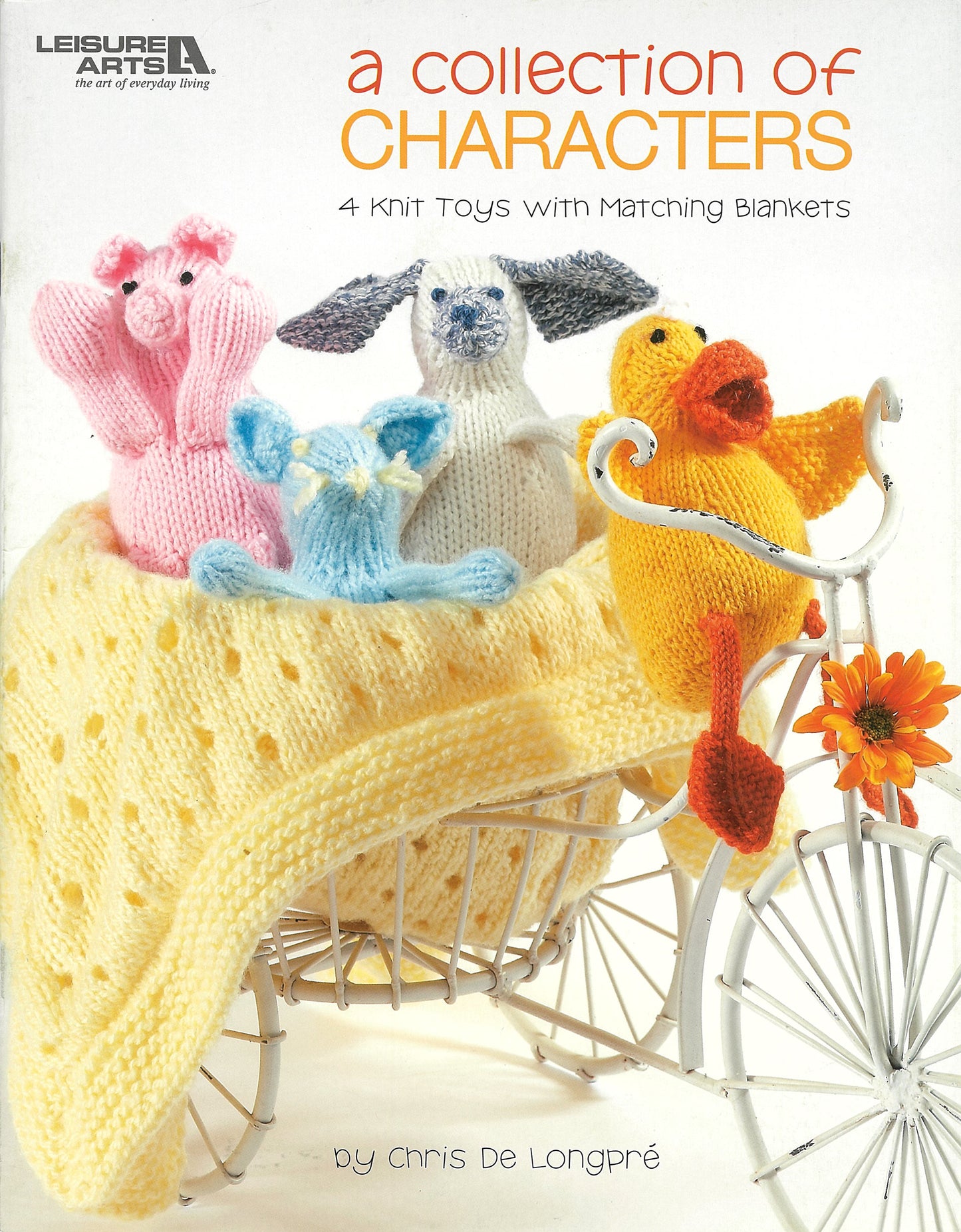 Four bright knit toys (pink pig, blue mouse, white lamb, yellow duck) sit in a white bicycle basket with matching blankets and an orange flower. Shown: "A Collection of Characters" book by Leisure Arts.