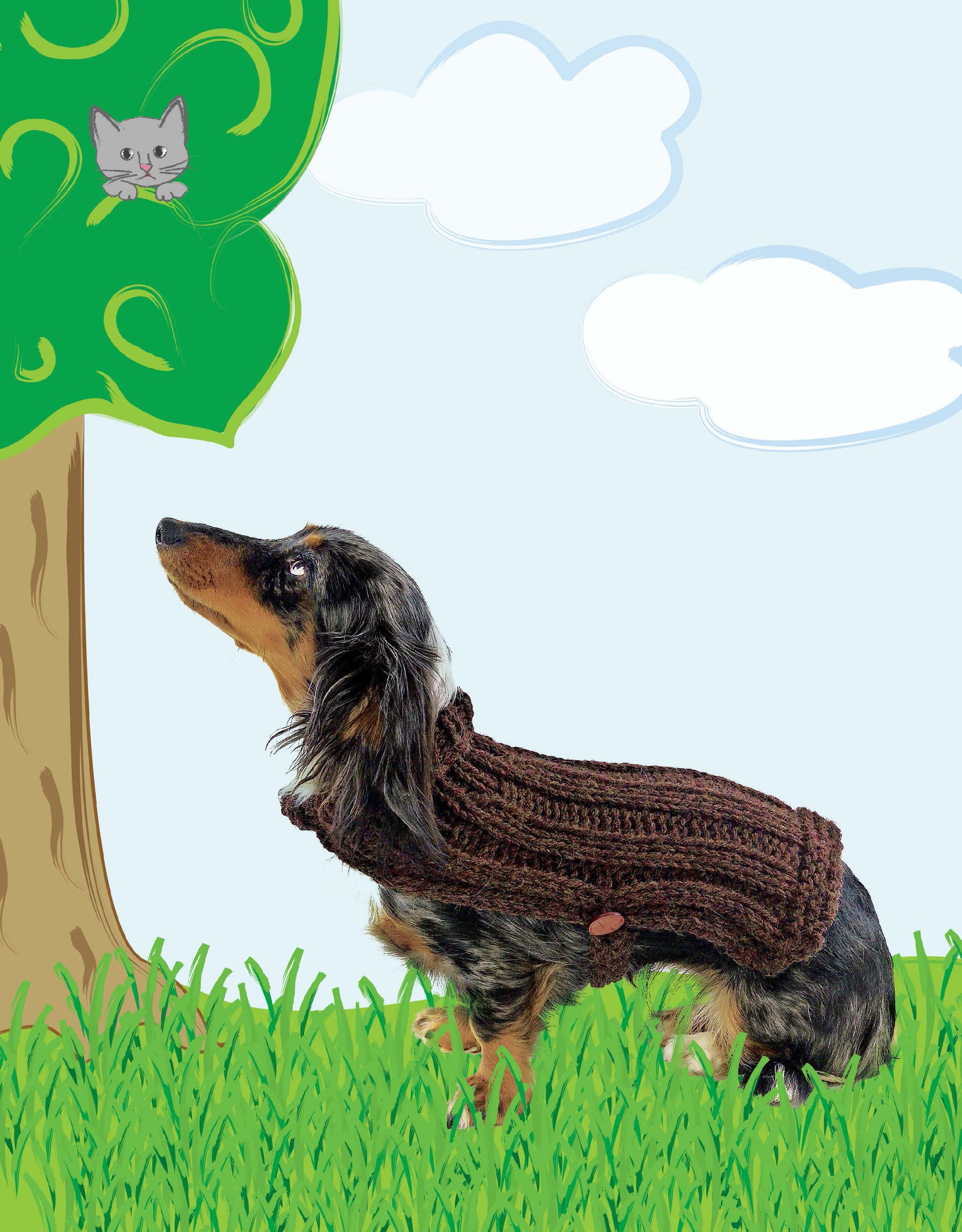 A dachshund in the "Oodles of Outerwear for Canines" brown yarn sweater by Leisure Arts looks up at a cartoon cat in a tree, with grassy ground and a cloudy sky behind them.
