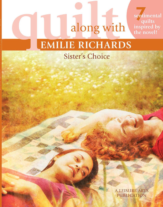 Two women relax on a quilt outdoors, smiling in the sun. The patterned quilt evokes tradition. This scene is the cover of "Quilt Along with Emilie Richards" by Leisure Arts, celebrating sentimental quilts and creative connections.