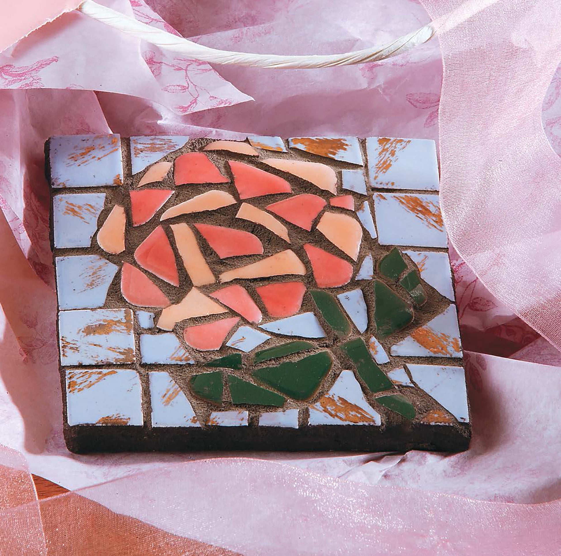 Heidi Borchers' Beginner's Guide to Mosaics by Leisure Arts features tips for creating elegant home decor, like square mosaic tiles of red and orange roses with green stems, white backgrounds, and pink accents—perfect for showcasing intricate designs.
