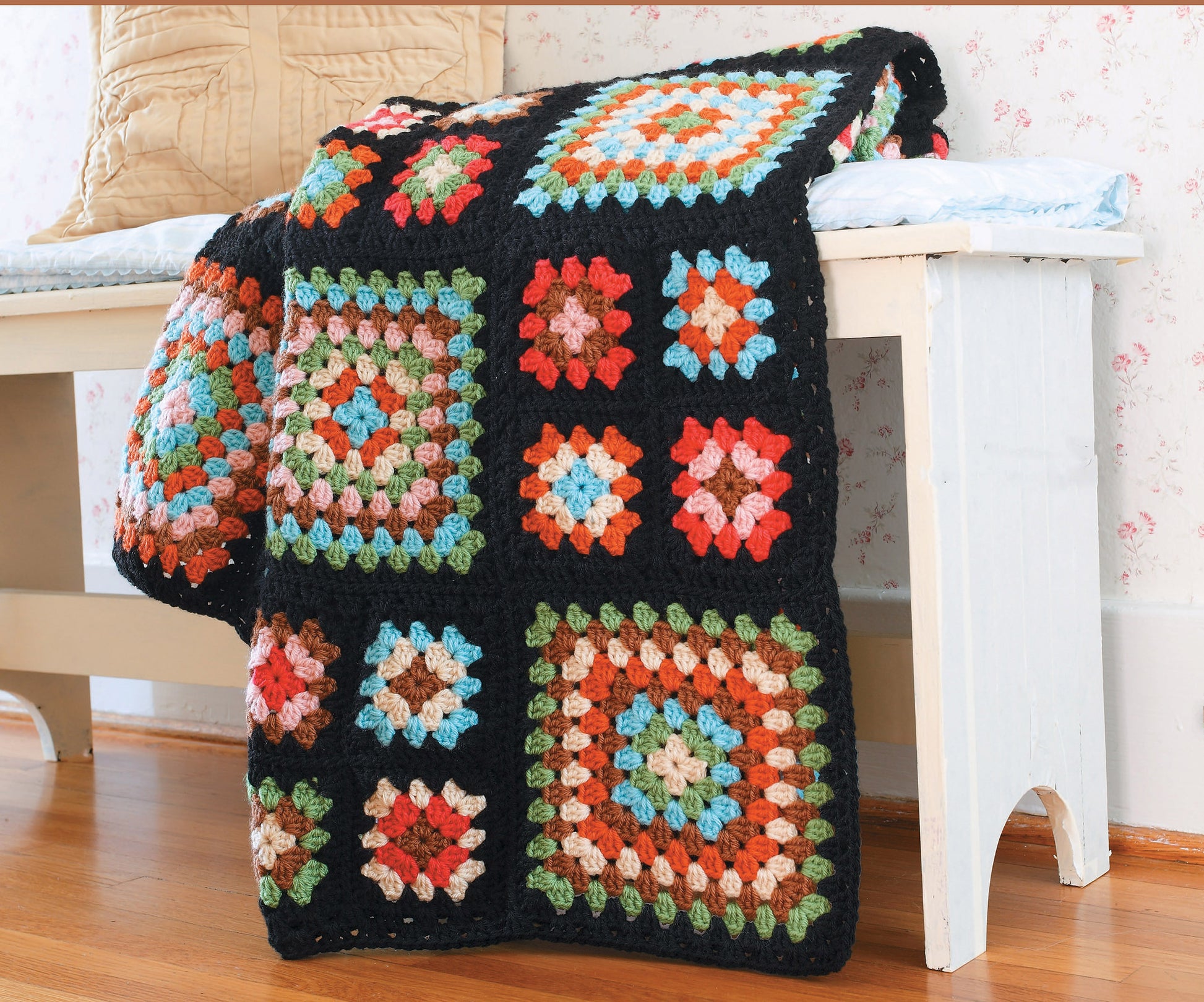 The Gooseberry Patch Farmhouse Crochet Digital Download by Leisure Arts features vibrant crochet patterns, perfect for creating a colorful granny square blanket to brighten up any cozy room.