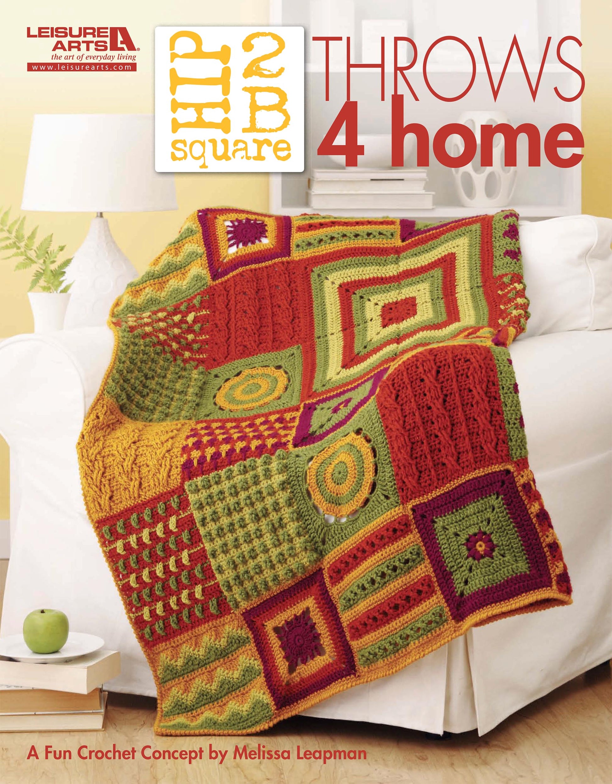A vibrant crochet throw blanket in red, green, and yellow decorates a white sofa. The text reads: Hip 2 B Square Throws 4 Home by Leisure Arts—a fun crochet concept designed by Melissa Leapman.