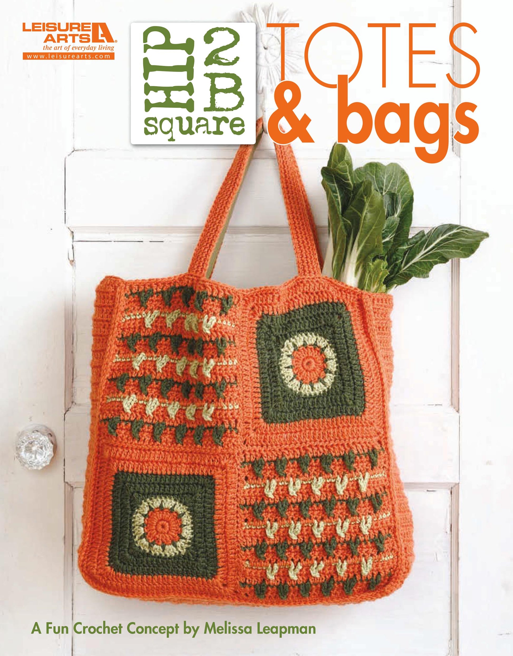 A crochet tote bag with orange, green, and cream square motifs hangs on a hook filled with leafy greens. The book cover reads "Hip 2 B Square Totes & Bags Digital Download" by Leisure Arts, featuring inspiring tote patterns.