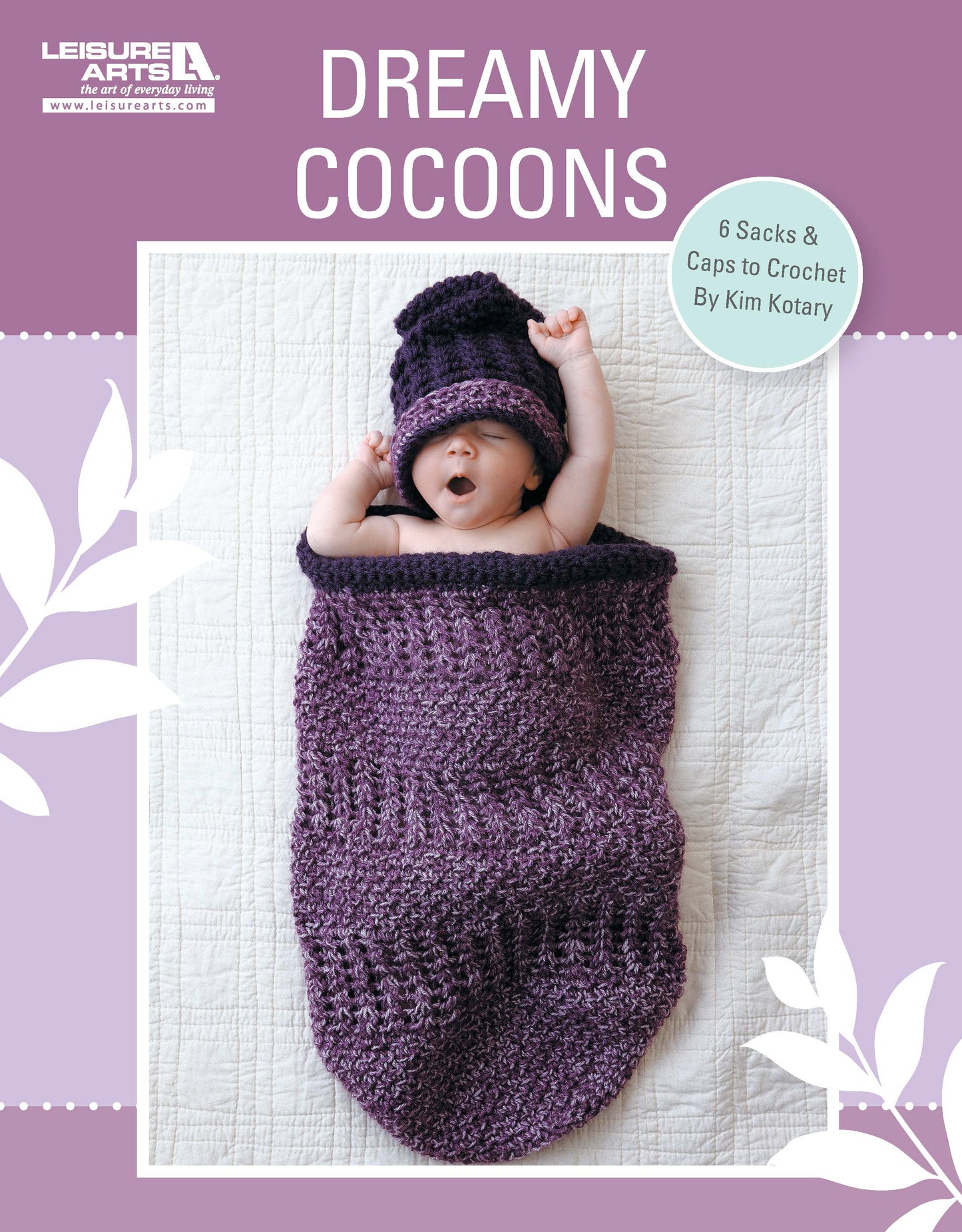 A baby lies on a white quilt, wrapped in a purple crochet cocoon with matching hat. This image is the cover of Crochet Dreamy Cocoons by Leisure Arts, featuring 6 charming crochet patterns for baby sacks and caps.