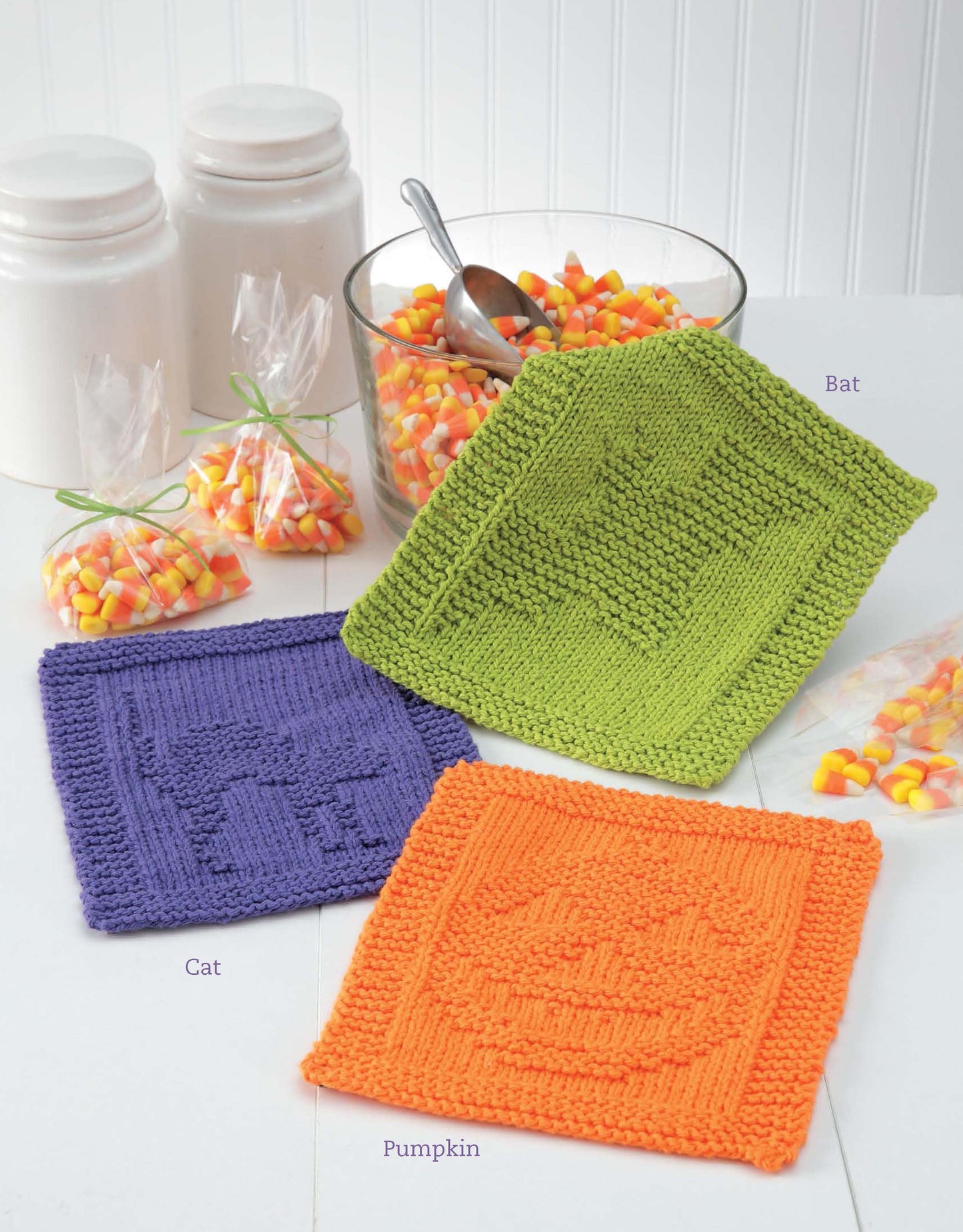Leisure Arts' Dishcloths for Special Days Digital Download features three knitted Halloween square cloths—a green bat, purple cat, and orange pumpkin—perfect quick gifts for knitters of all skill levels.
