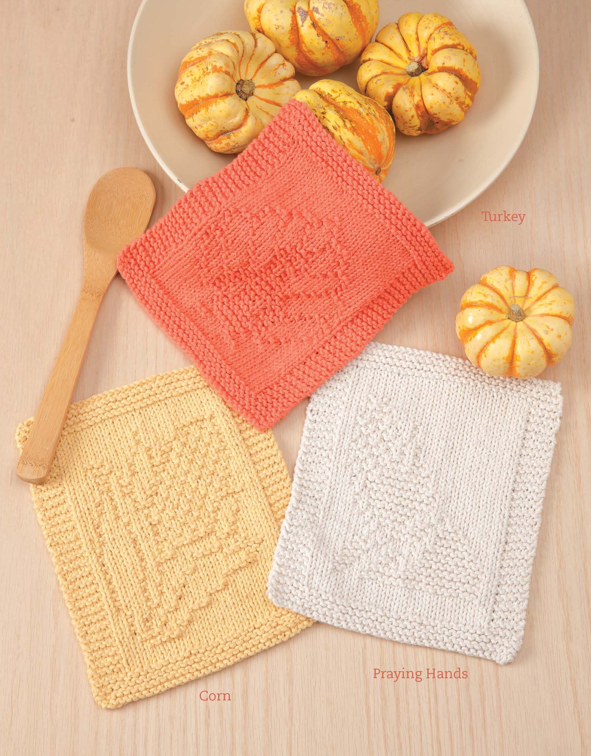 Leisure Arts’ "Dishcloths for Special Days Digital Download" features turkey, corn, and praying hands dishcloths—quick, easy knits perfect as year-round gifts or beginner projects. Shown on a wood table with gourds and a wooden spoon.