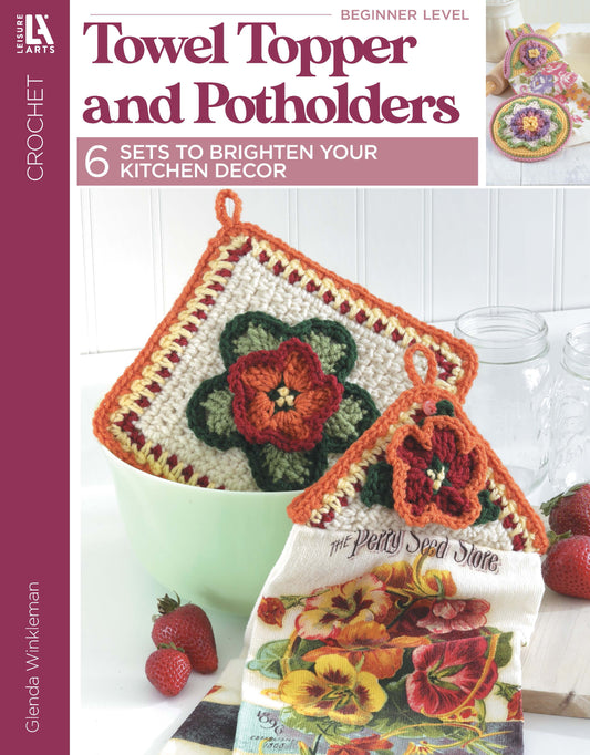 Cover of Leisure Arts’ "Towel Toppers and Potholders Digital Download": colorful crochet pot holders hang above a strawberry-themed kitchen towel—perfect for adding charm to your kitchen or gifting. Fresh strawberries and jars displayed in the background.