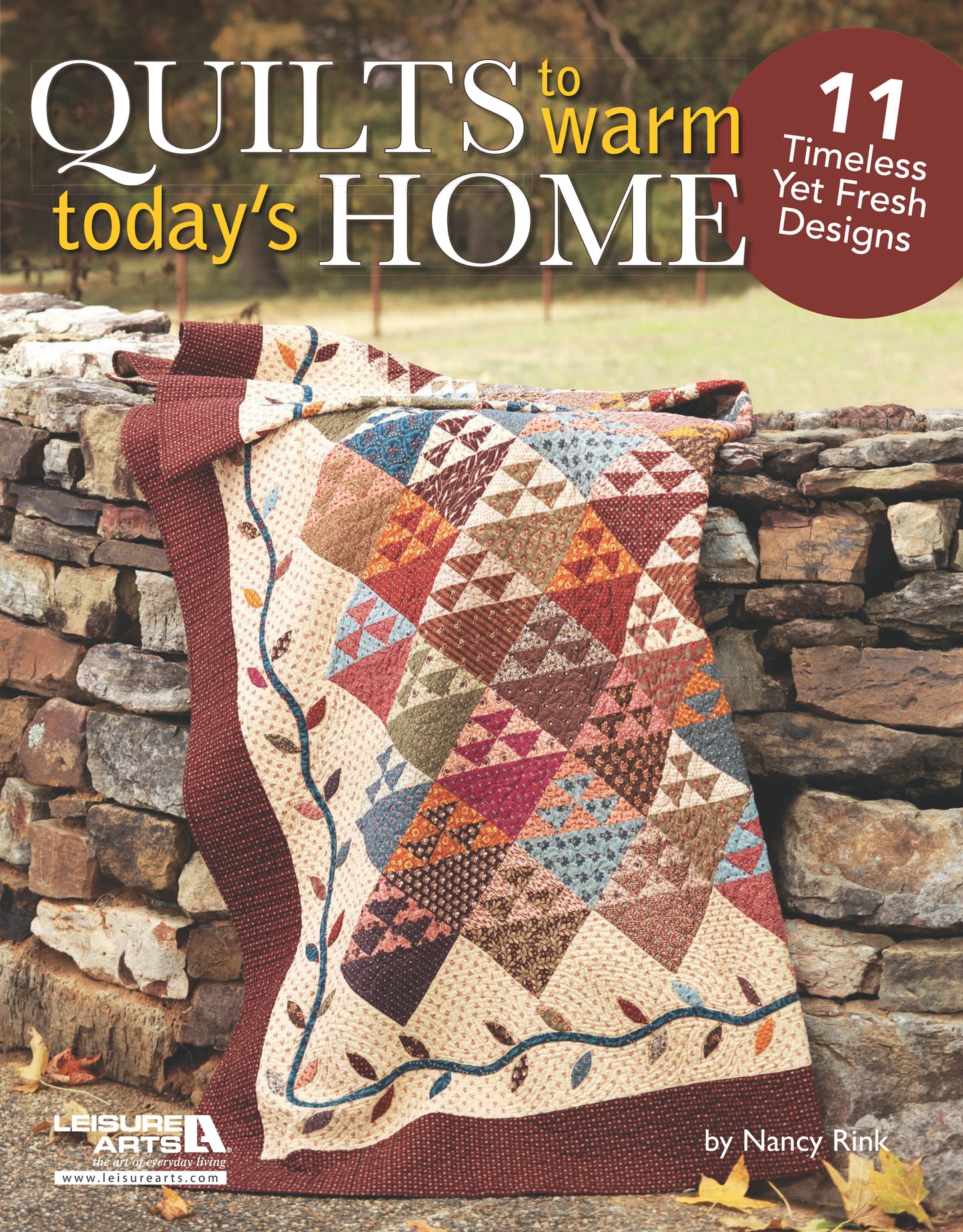 A colorful patchwork quilt with red, blue, and cream diamonds is draped over a stone wall. Overlaid text features “Quilts to Warm Today's Home Digital Download” by Leisure Arts, offering 11 homestyle quilt projects and patterns.