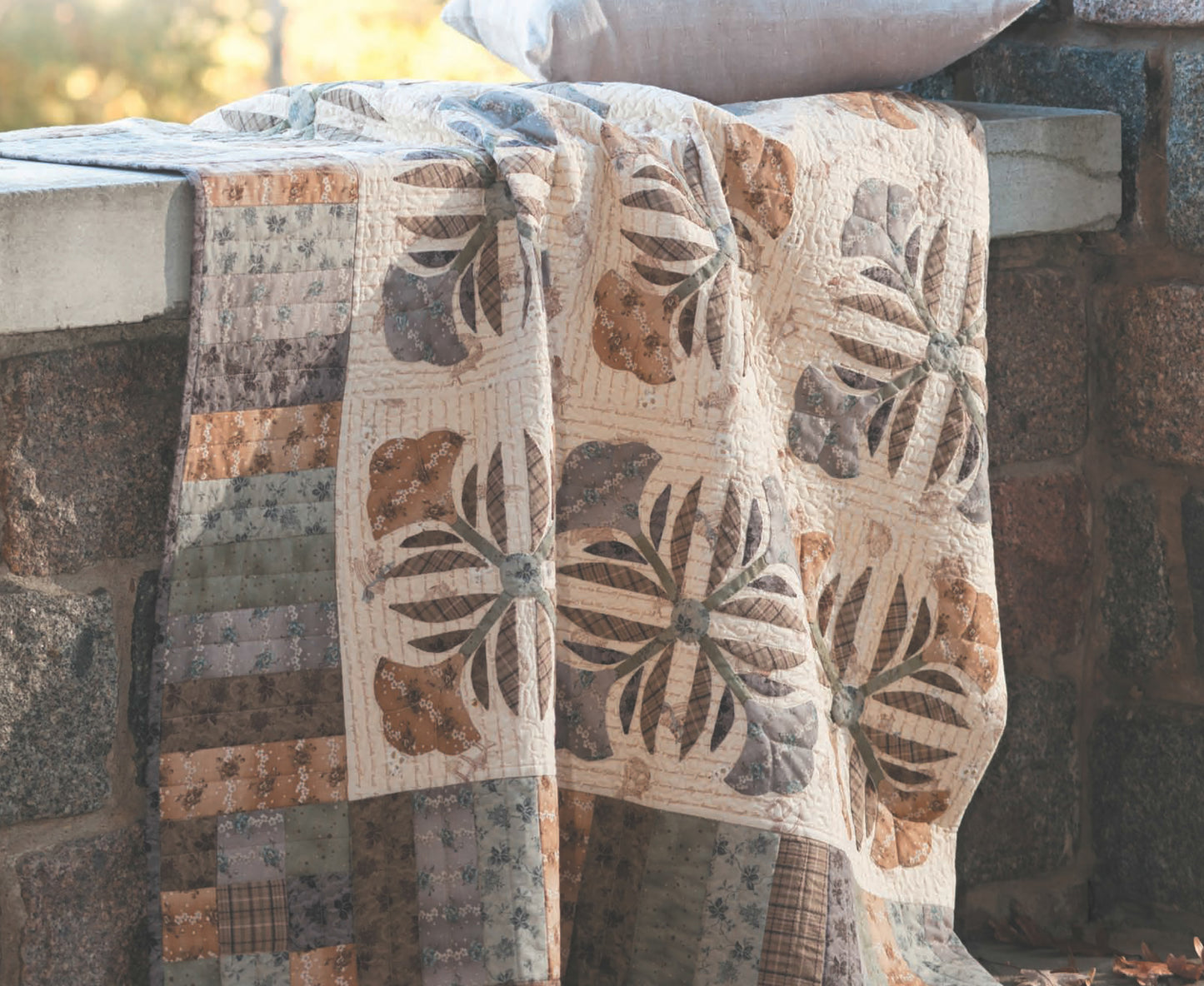 The "Quilts to Warm Today’s Home" digital download by Leisure Arts features classic quilt patterns in earthy tones and floral patchwork, perfect for adding handmade warmth and style to your space.