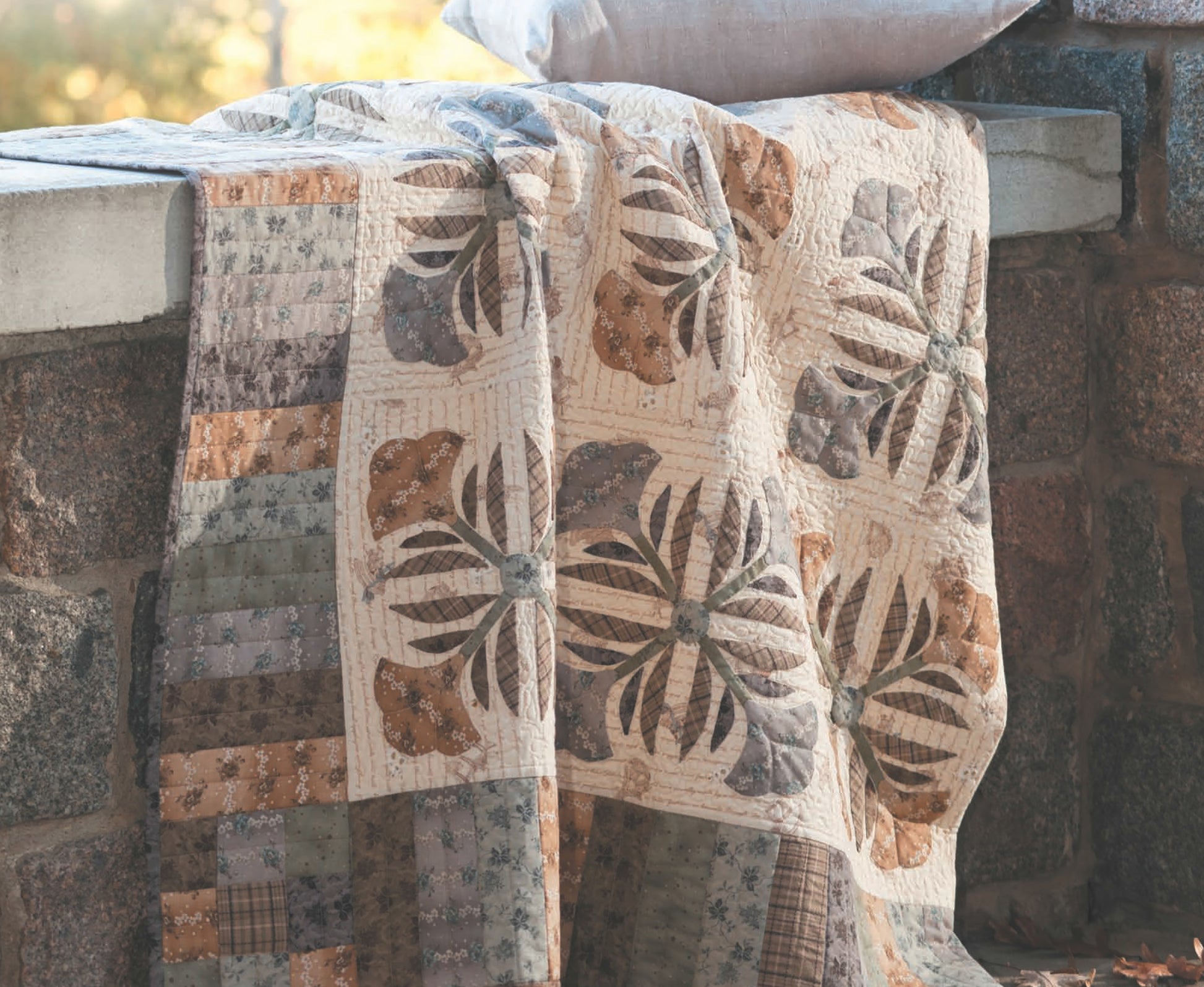 The "Quilts to Warm Today’s Home" digital download by Leisure Arts features classic quilt patterns in earthy tones and floral patchwork, perfect for adding handmade warmth and style to your space.