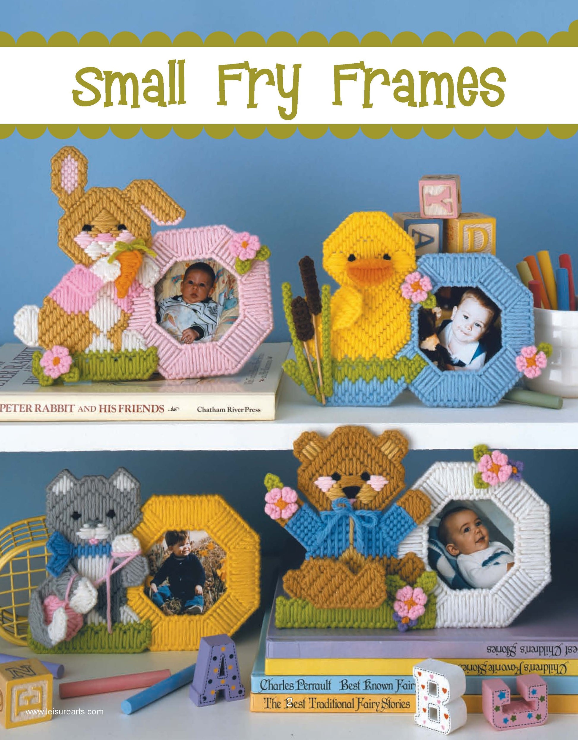Leisure Arts’ Friends for Baby in Plastic Canvas Digital Download features colorful, handmade animal photo frames—a bunny, chick, cat, and bear—to display baby photos on white shelves with books and blocks. Perfect adorable baby gifts!.