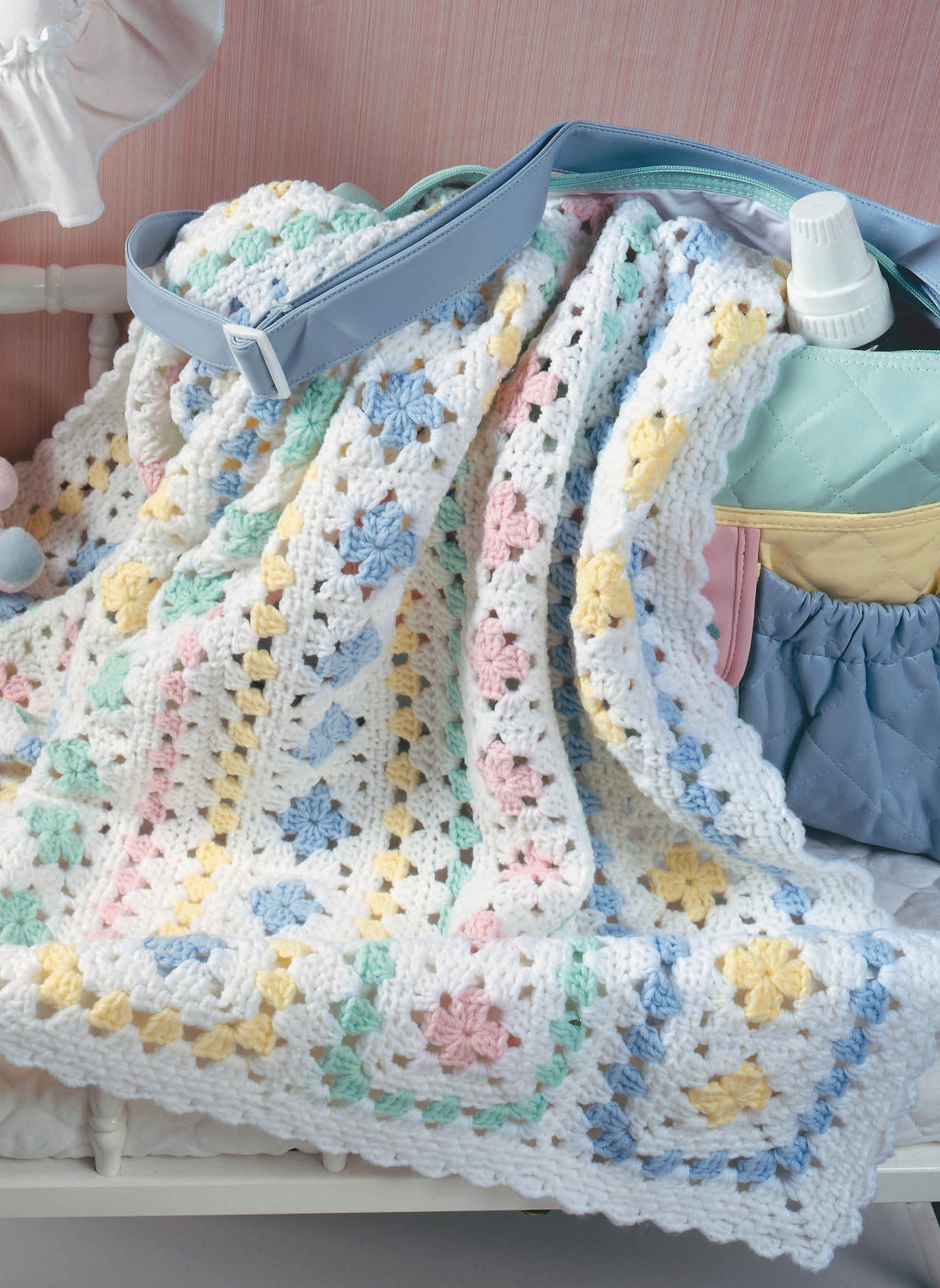 Leisure Arts’ "Baby Afghans — 8 Cozy Wrap Patterns for Your Special Wee One" offers pastel crochet blanket designs—think white, yellow, pink, blue, and green squares—ideal for beginners looking to create a charming nursery touch.