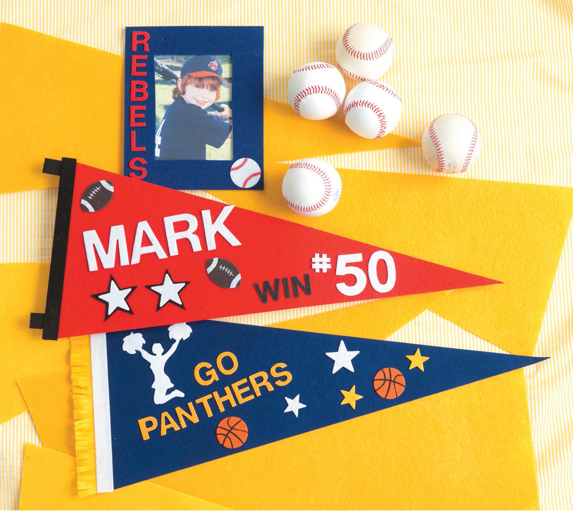 Crafting with Felt by Leisure Arts features two starry felt pennants—red and blue—plus playful details like a cheerleader, basketballs, toy baseballs, and a child’s photo for charming kids toys-inspired home decor.