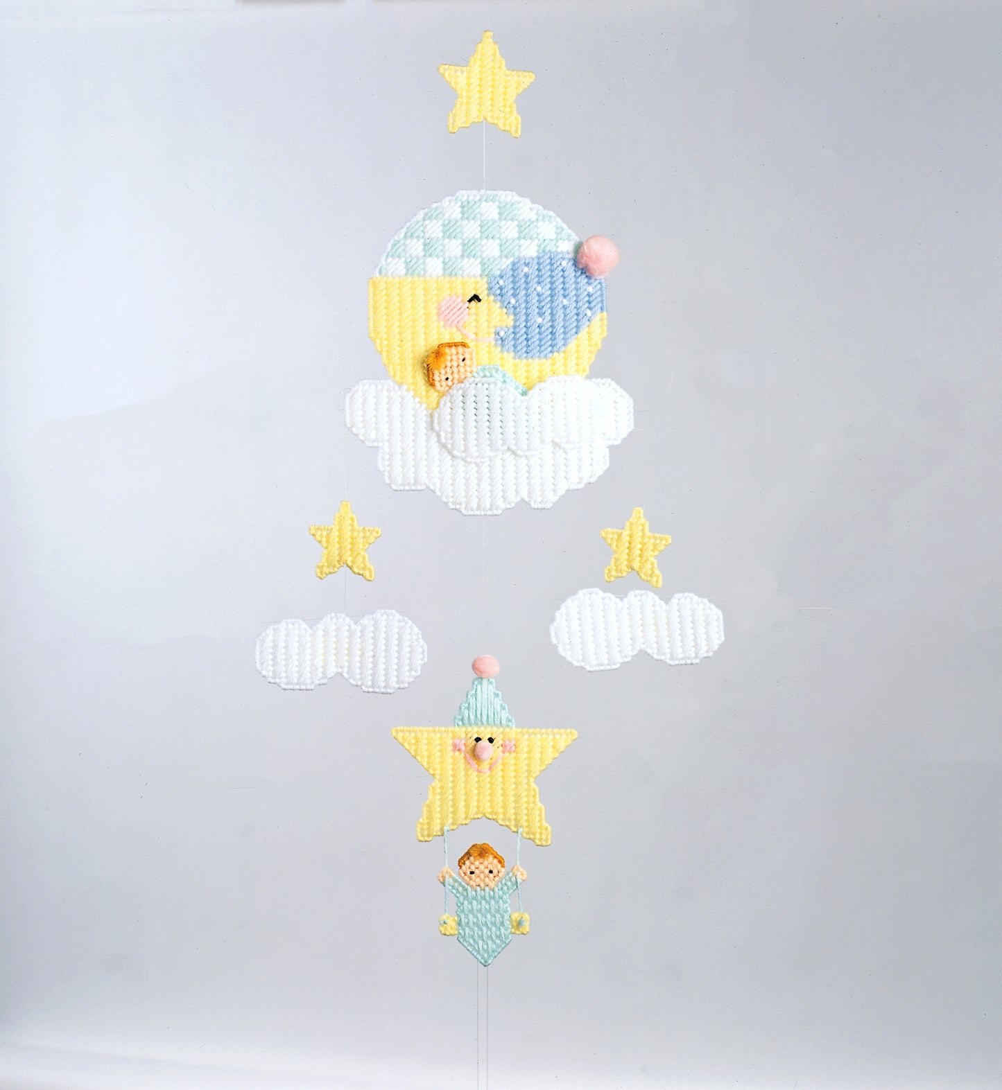 A Star Is Born by Leisure Arts features embroidery art of a moon and star scene with clouds, sleeping bears, pom-poms, and stars—adorable nursery decor for dreamy baby rooms.