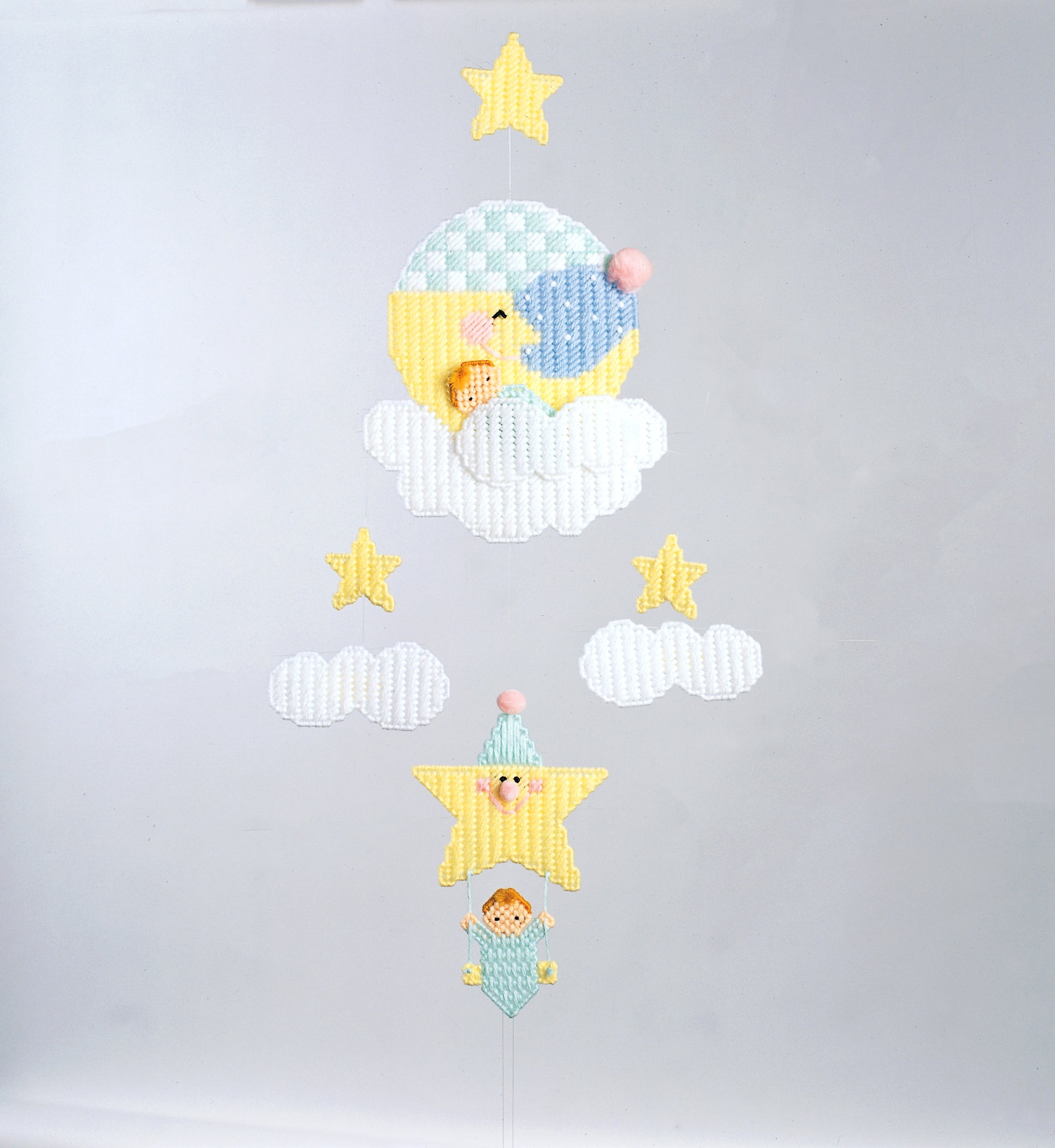 A Star Is Born by Leisure Arts features embroidery art of a moon and star scene with clouds, sleeping bears, pom-poms, and stars—adorable nursery decor for dreamy baby rooms.