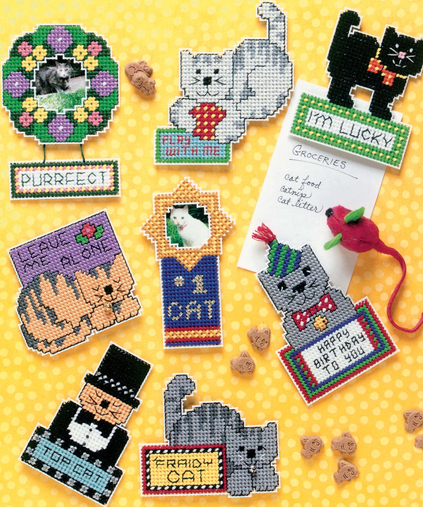Cat Chat Magnets by Leisure Arts: playful cat-themed magnets with designs like “PURRfect,” a “Groceries” note, and a toy mouse, displayed on yellow polka-dots—fun feline kitchen decor or a great gift for cat lovers.