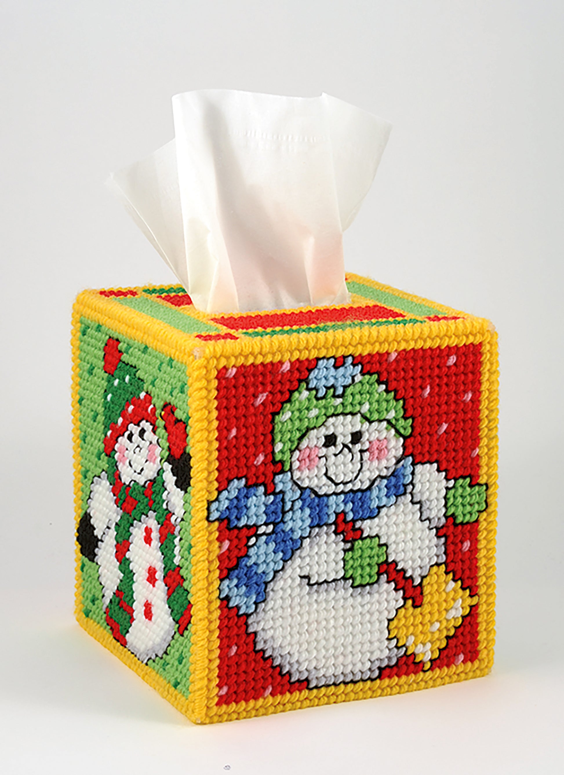 Leisure Arts’ Tissue Box Covers—8 Projects to Brighten Up Any Room in Your Home offers festive needlepoint designs, like Christmas-themed covers with snowmen on red and green panels, made with plastic canvas patterns and worsted weight yarn.