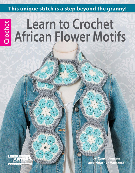 A denim jacket is styled with a blue, white, and gray African flower scarf. The "Learn to Crochet African Flower Motifs Digital Download" by Leisure Arts offers step-by-step patterns for beautiful worsted weight yarn projects.