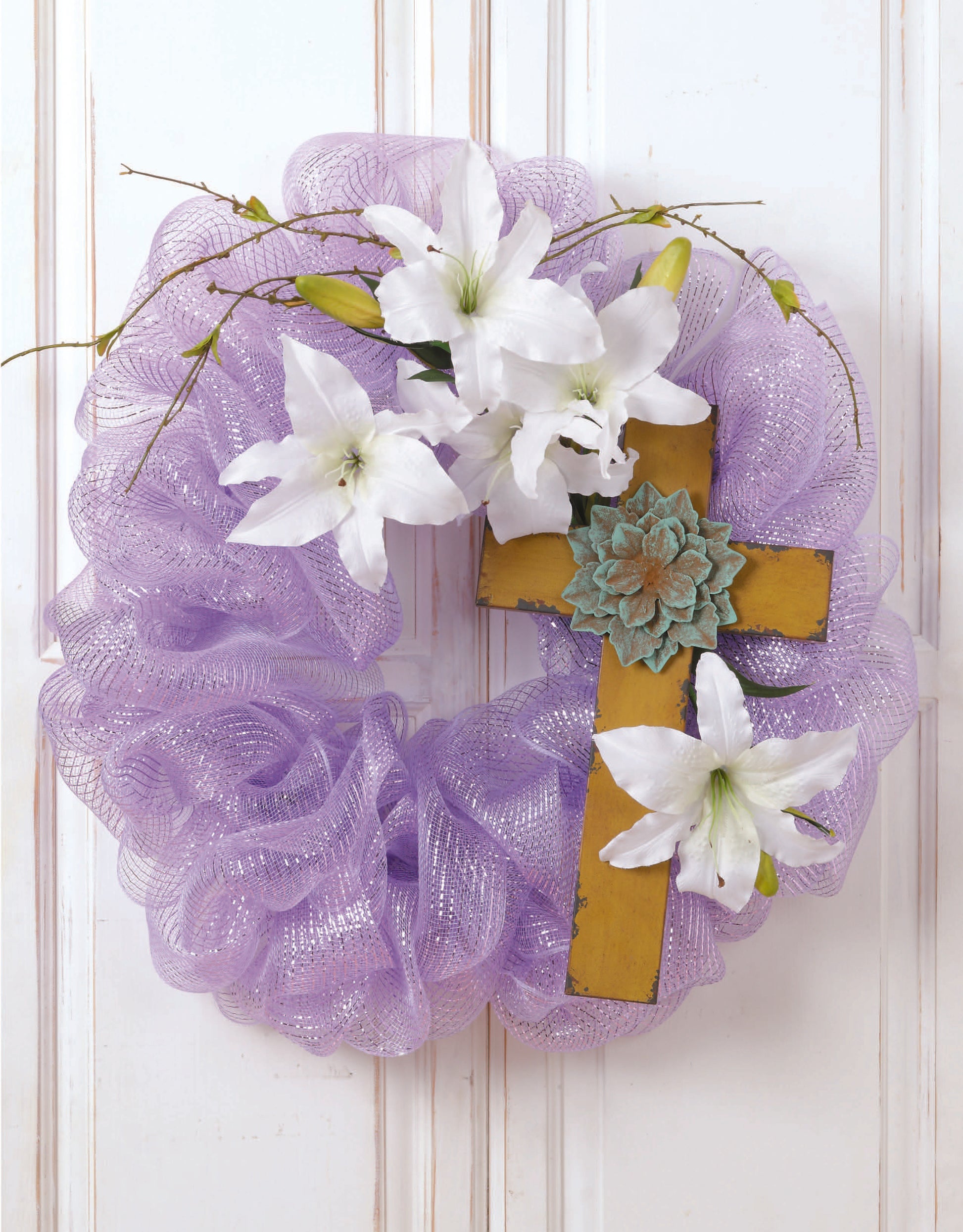 Create beautiful home décor with the Leisure Arts "Learn to Make Deco Mesh Wreaths" kit—featuring lavender mesh, white lilies, green buds, a succulent, and a gold cross on a wire frame—perfect for hanging on your wall.