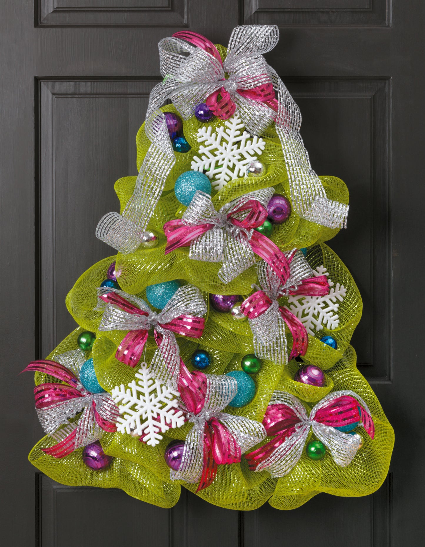 The "Learn to Make Deco Mesh Wreaths" kit by Leisure Arts helps you craft festive Christmas tree-shaped wreaths with mesh, snowflakes, ribbons, and colorful ornaments—perfect for wreath making enthusiasts!.