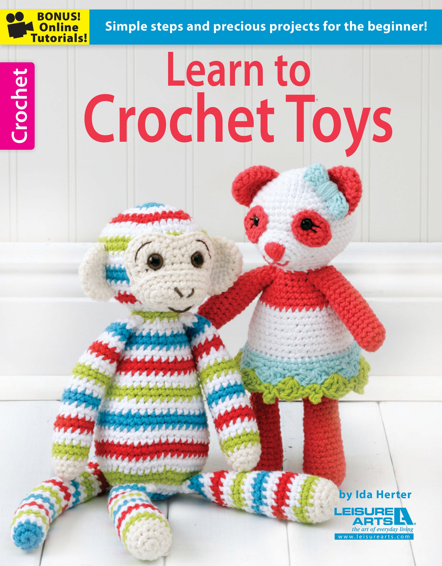 Cover of "Learn to Crochet Toys" by Leisure Arts, showcasing amigurumi crochet animals—a colorful monkey and a red-and-white panda in a green skirt. This book features easy beginner crochet projects and toy patterns.