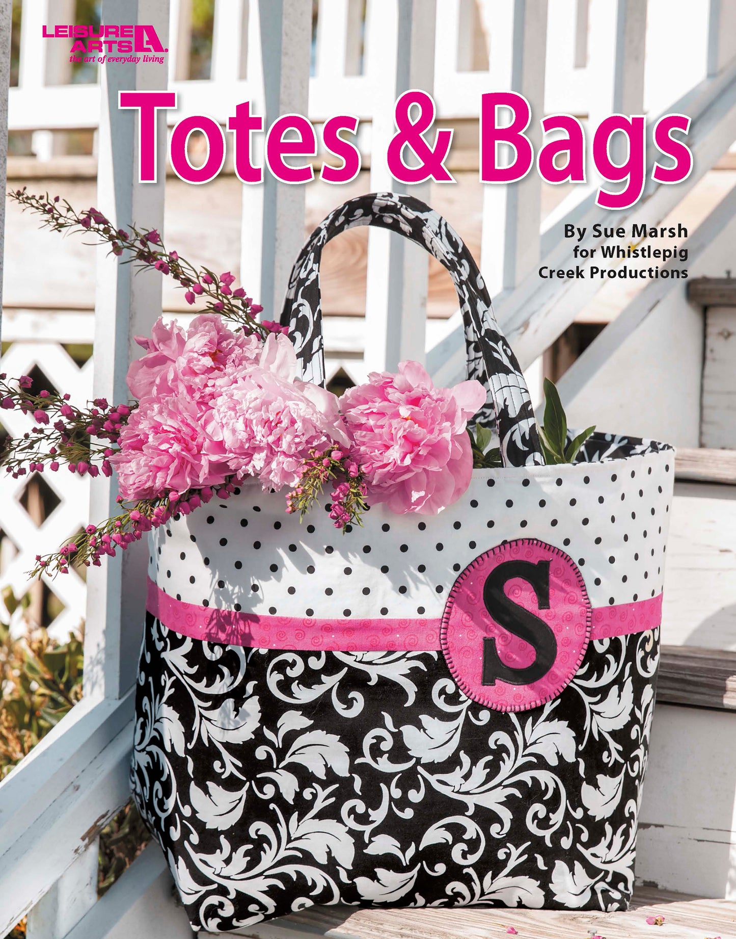 The Sew Totes & Bags Digital Download by Leisure Arts features a chic black and white tote with a pink accent and letter S, filled with pink peonies and greenery on a white chair outdoors. Perfect for stylish bag enthusiasts. Title: Totes & Bags.