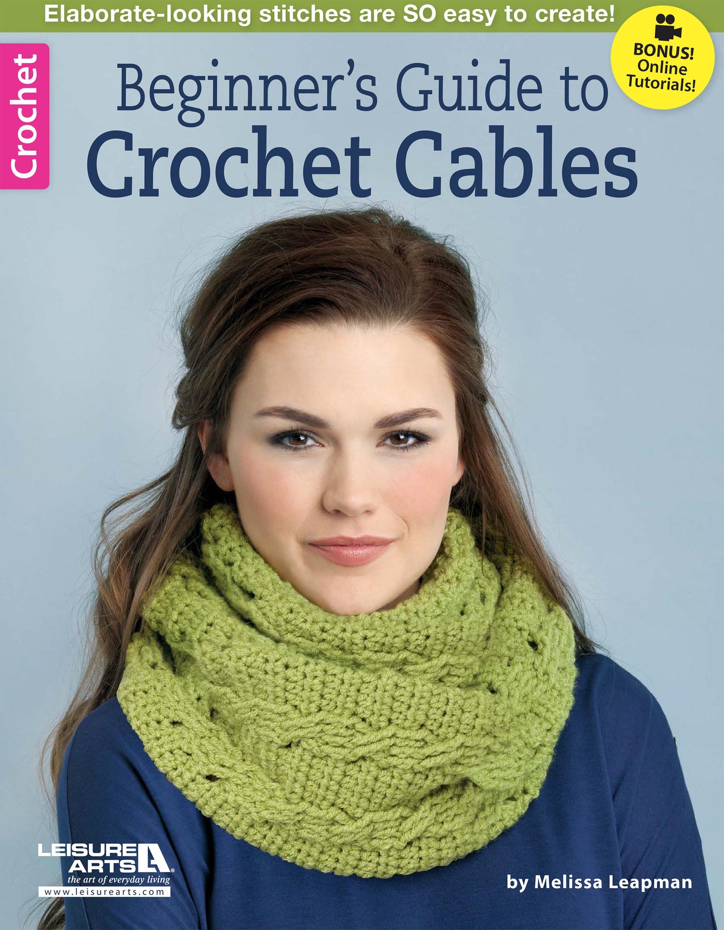 On the cover of Leisure Arts' Beginner's Guide to Crochet Cables, a woman models a chunky green crochet cowl made with easy post stitches. Includes online tutorials—ideal for mastering crochet cable patterns.