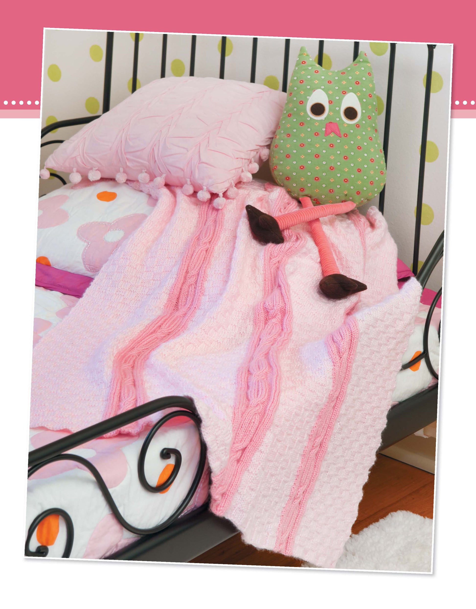 Find inspiration for beginner baby knitting projects with Projects for Baby Made with the Knook by Leisure Arts. Imagine a cozy black metal bed dressed in pink and floral bedding, plus decorative pink and green cat pillows.