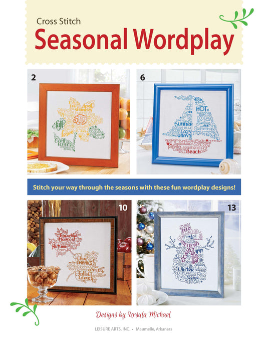 The cover shows three framed seasonal word cloud cross stitch designs on 14-count Aida, with cookies and a mug by the bottom-left frame. Text reads "Seasonal Wordplay Cross Stitch Digital Download" by Leisure Arts.