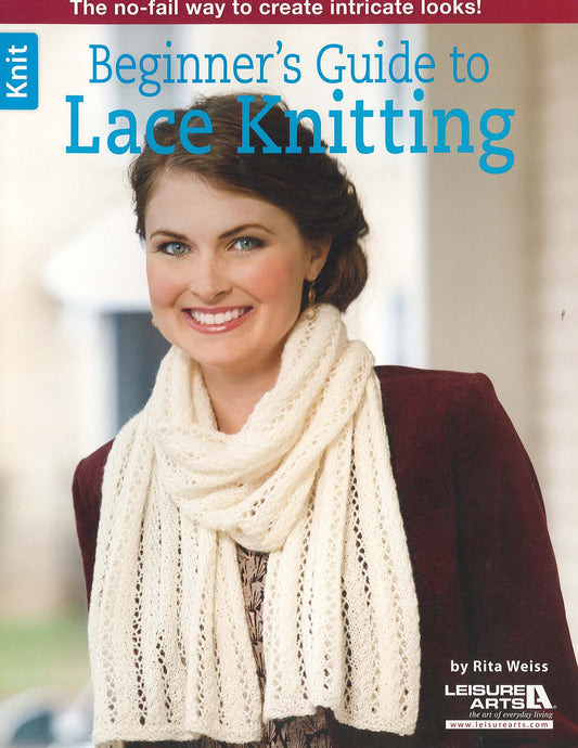 A smiling woman with brown hair, wearing a white lace scarf and maroon jacket, appears on the cover of Beginner's Guide to Lace Knitting by Leisure Arts, which features inspiring projects for new knitters against a softly blurred background.