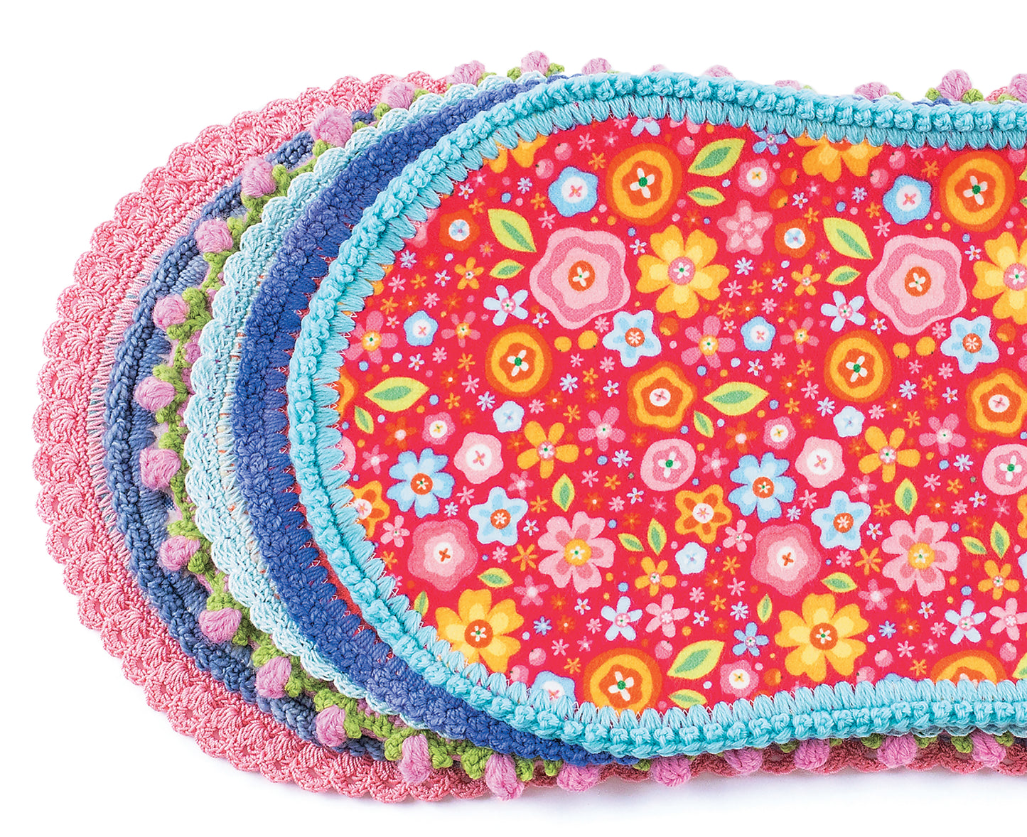 A stack of colorful oval fabric placemats with crochet edgings from Leisure Arts' "Edgings for Kids," featuring bright floral patterns, arranged overlapping on a white background—a perfect beginner crochet project.