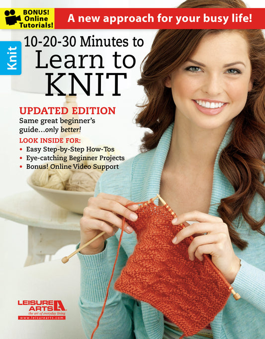 A smiling woman in a light blue sweater holds orange knitting needles and yarn. The text promotes "10-20-30 Minutes to Learn to Knit" by Leisure Arts, a beginner’s guide with step-by-step instructions and online video tutorials.