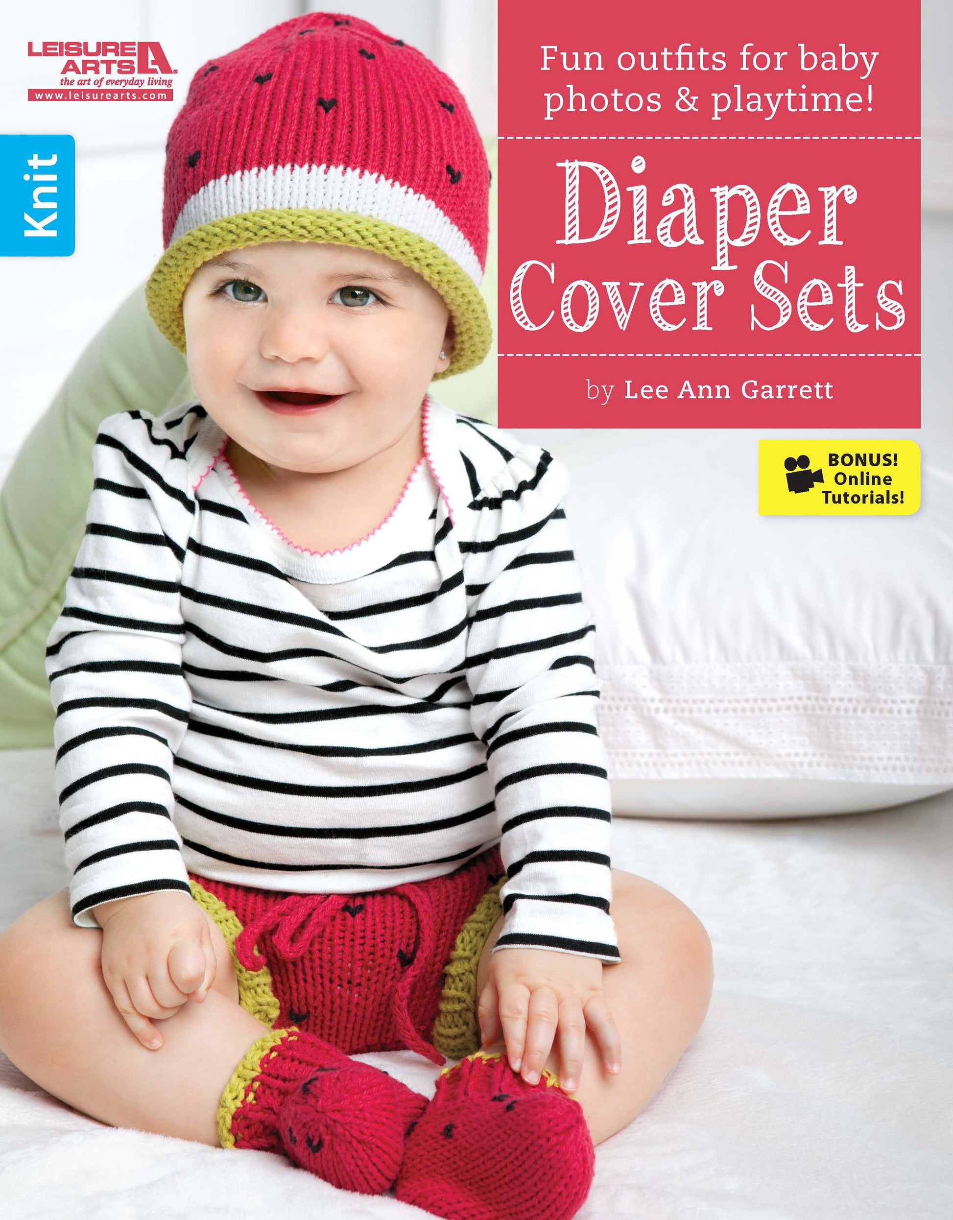 A smiling baby in a pink knit hat, striped shirt, and green-and-pink diaper covers with matching booties sits on a white surface. Diaper Cover Sets—Fun Outfits for Baby Photos & Playtime! by Leisure Arts. Bonus! Online Tutorials!.